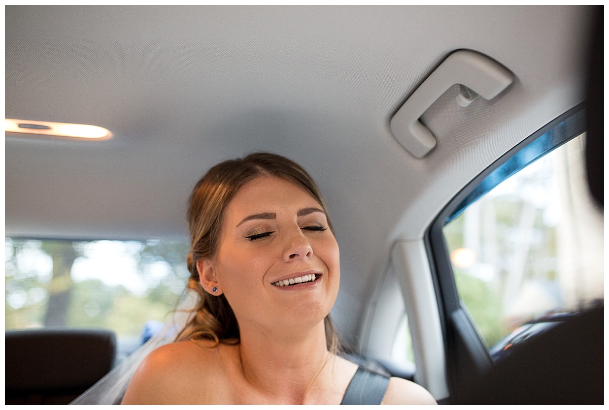 Bride in the back of the wedding car