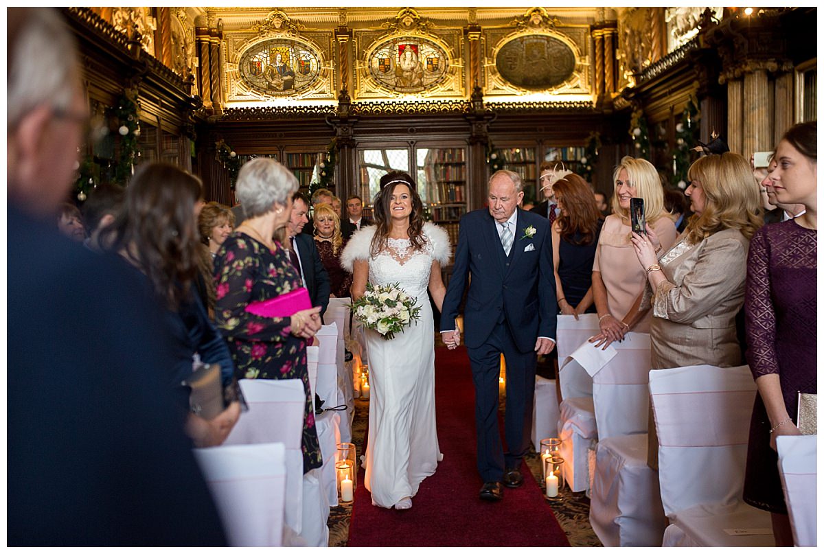Bride walking down the aisle with her father at Crewe Hall, Cheshire