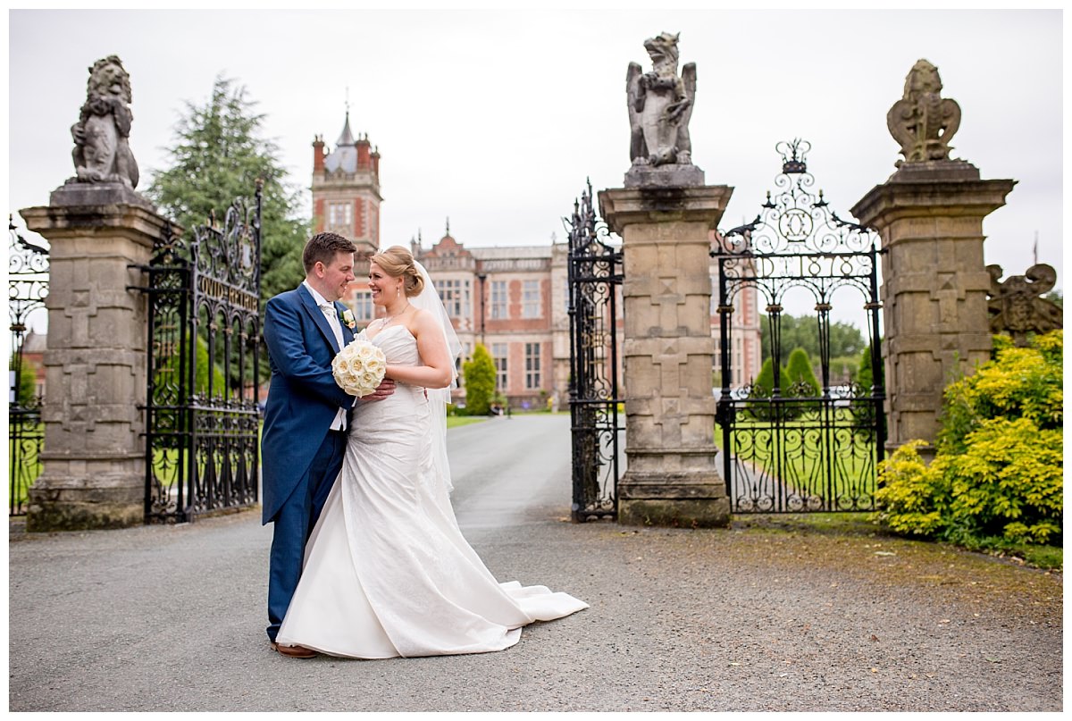 Bride and groom outside the gates of Crewe Hall