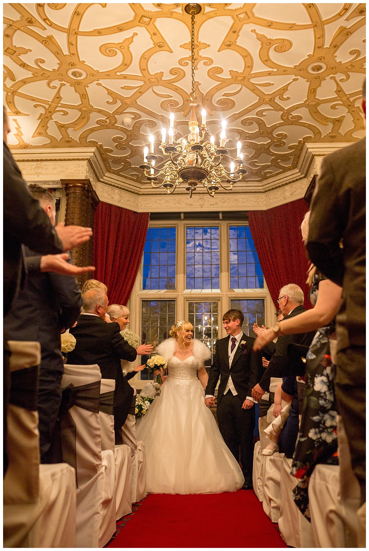 Bride and groom walking down the aisle at Crewe Hall