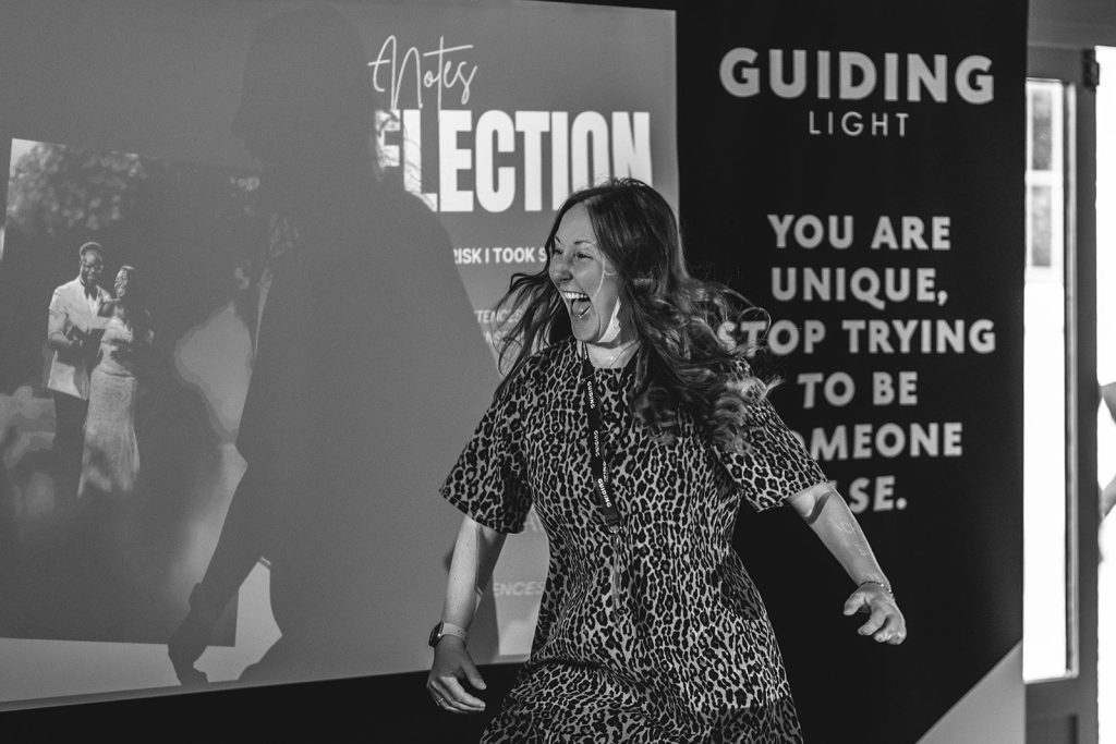Helen Williams speaking on stage at the Guiding Light photography conference