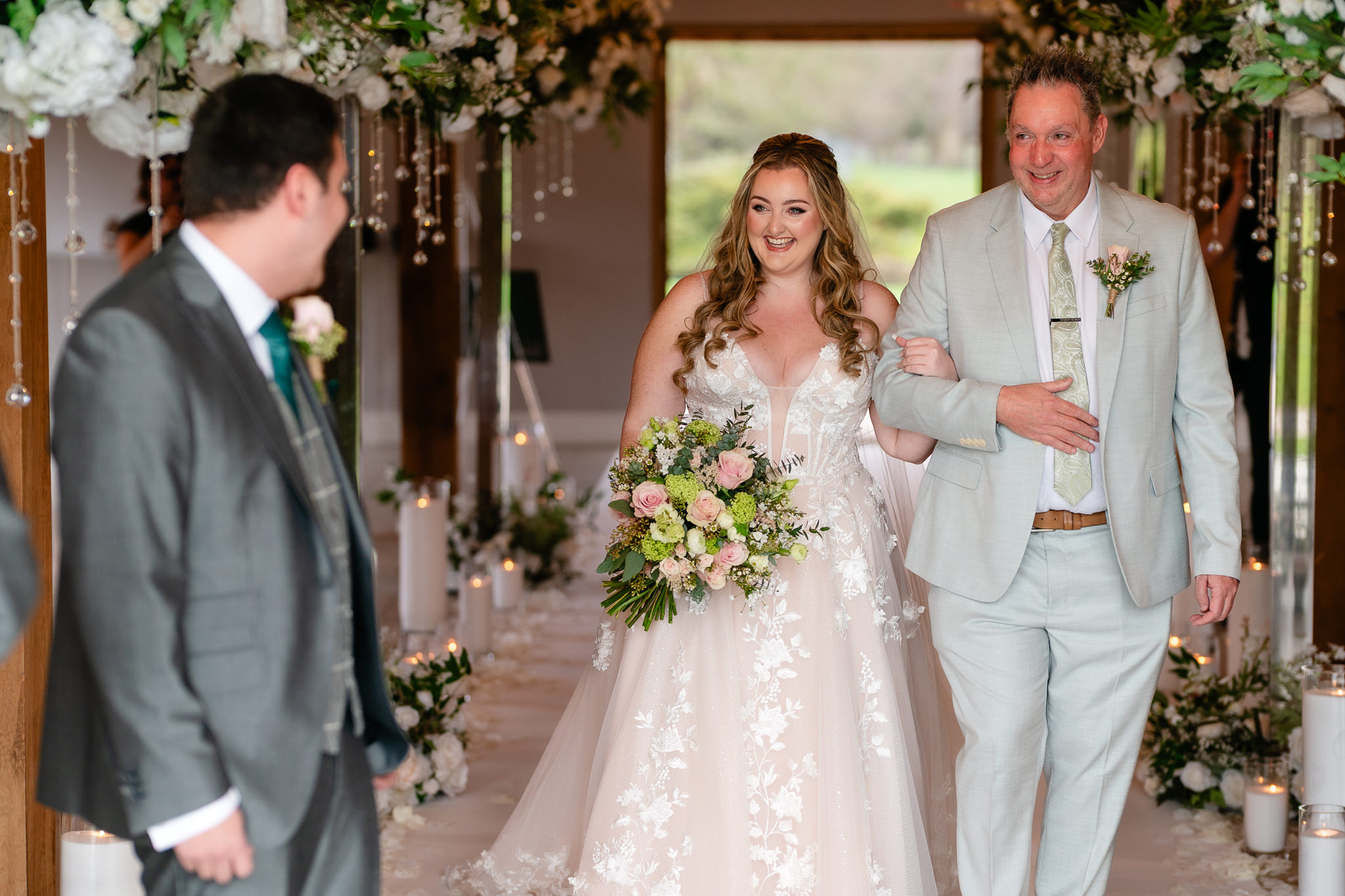 Bride walking down the aisle on her father’s arm at Merrydale Manor, Cheshire wedding photographer