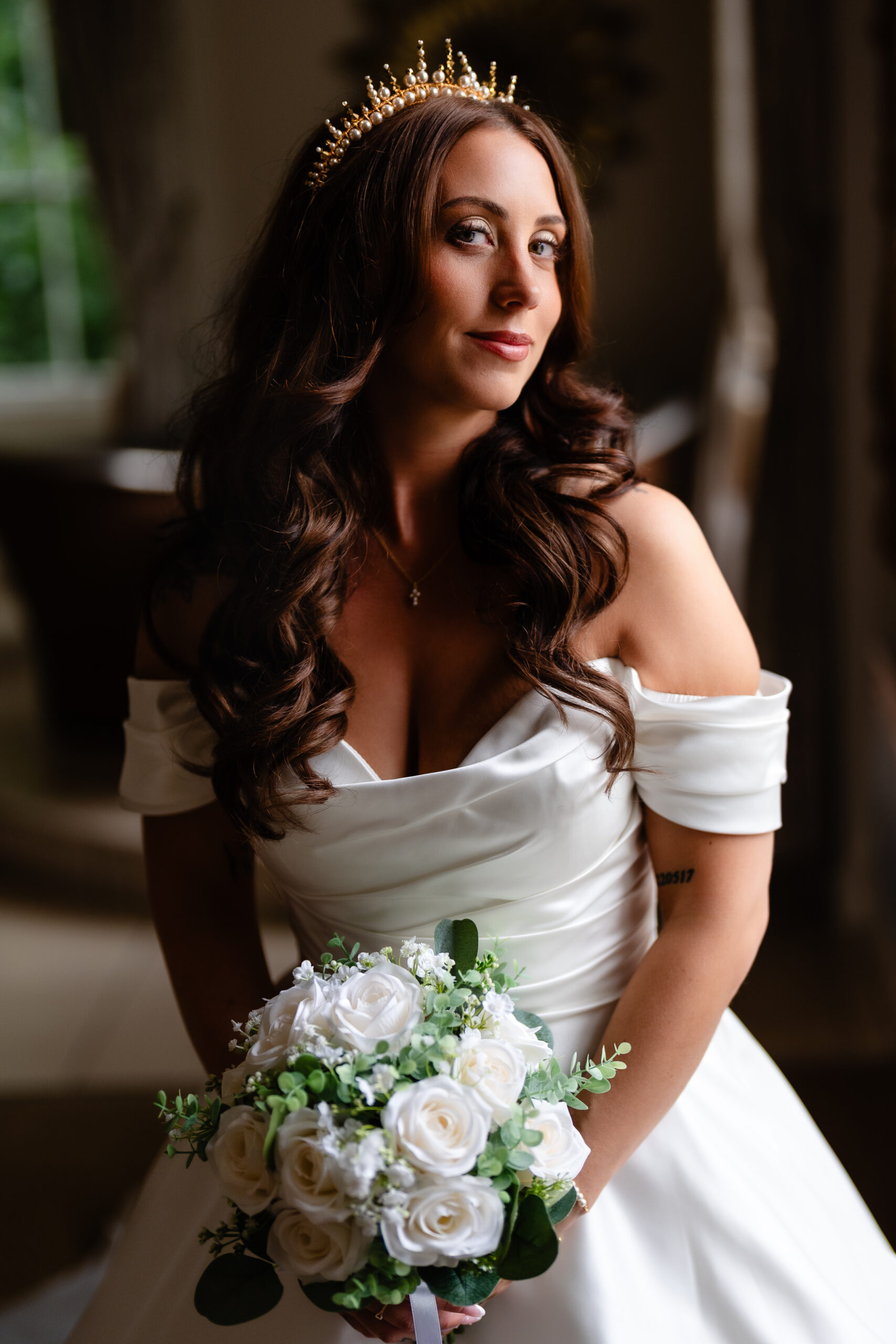 Bride portrait holding her bouquet before a Rainhill Hall wedding
