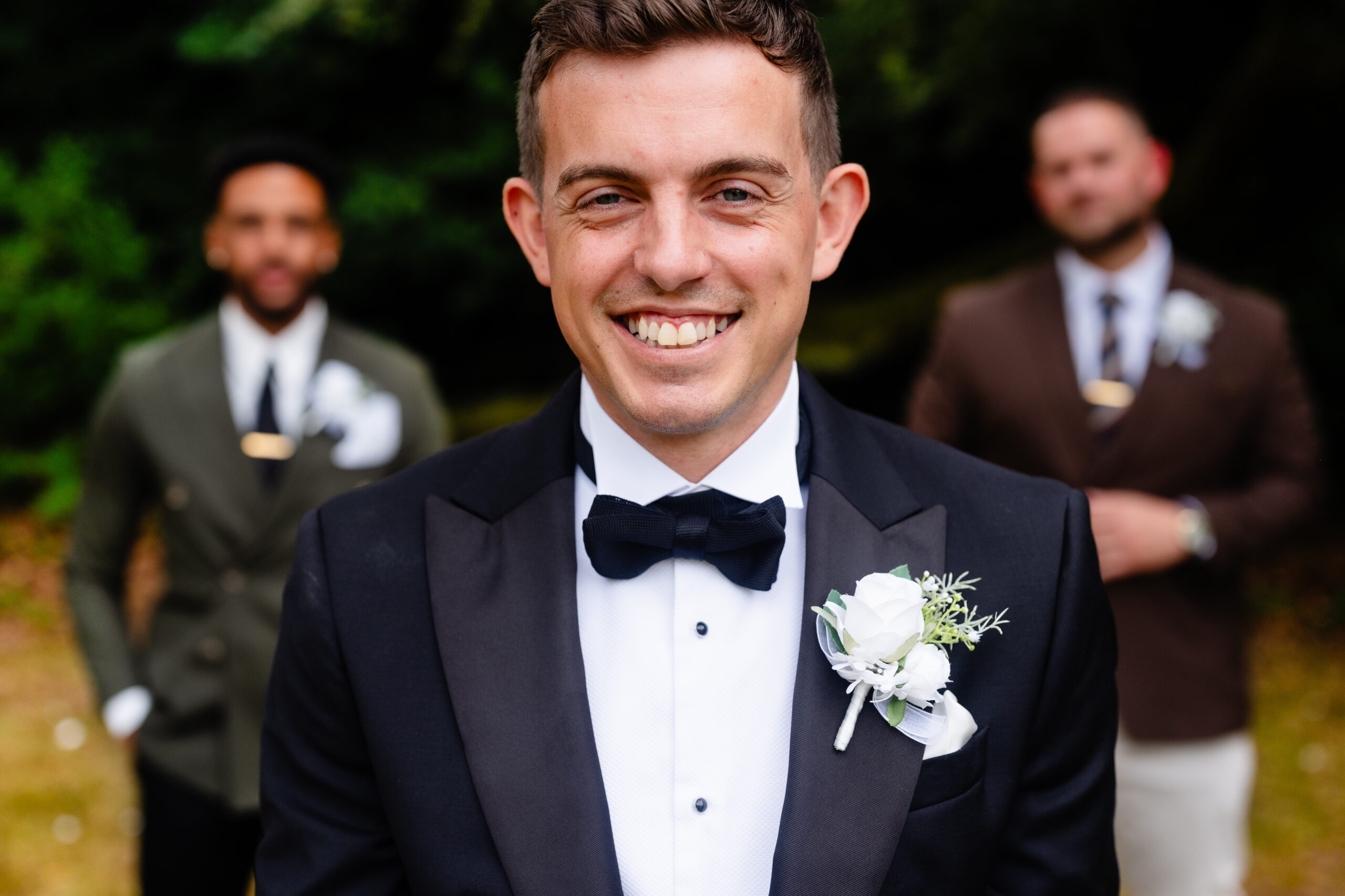 Groom and groomsmen laughing together before a Liverpool wedding