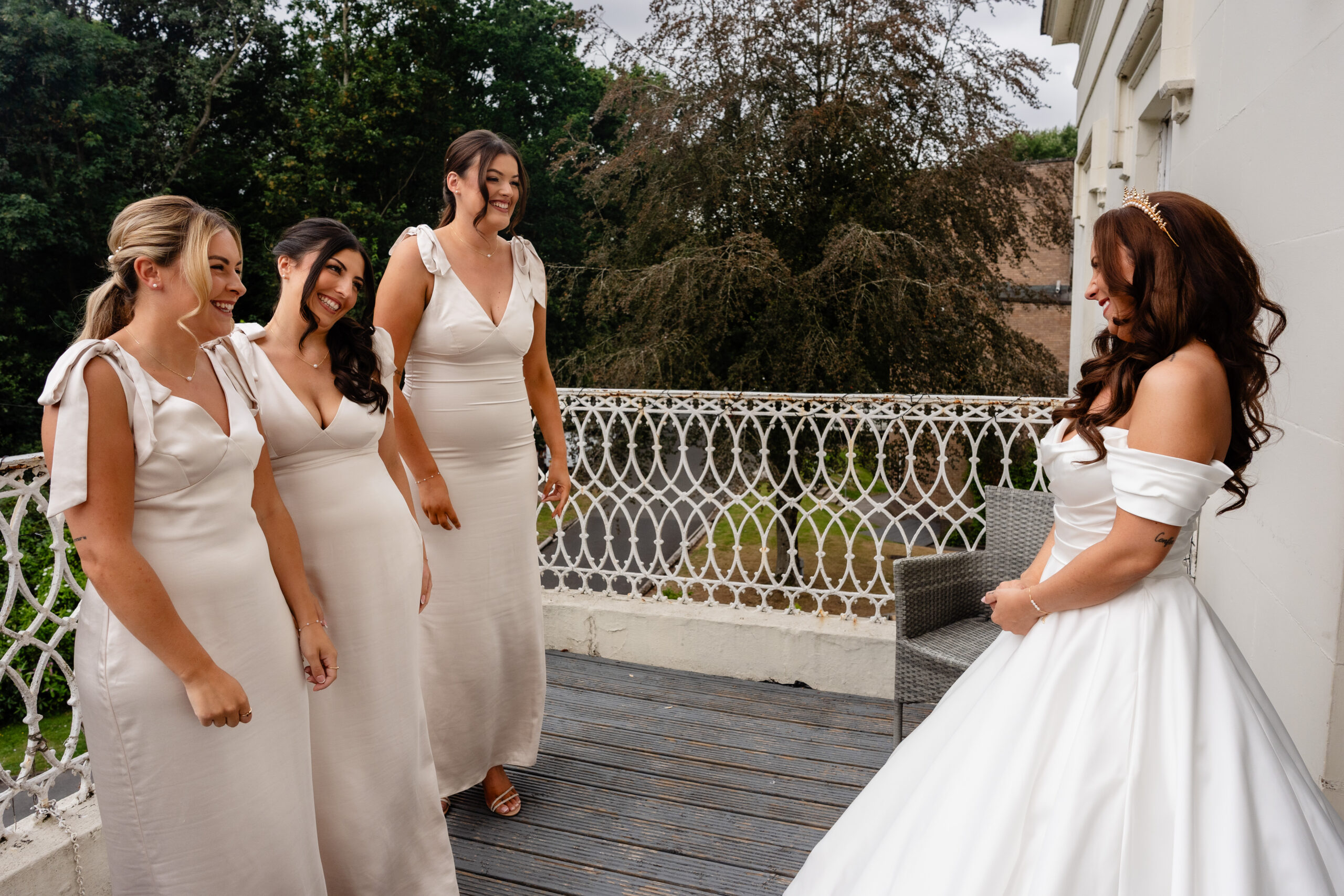 Bridesmaids walking out to see the bride for the first look at Rainhill Hall