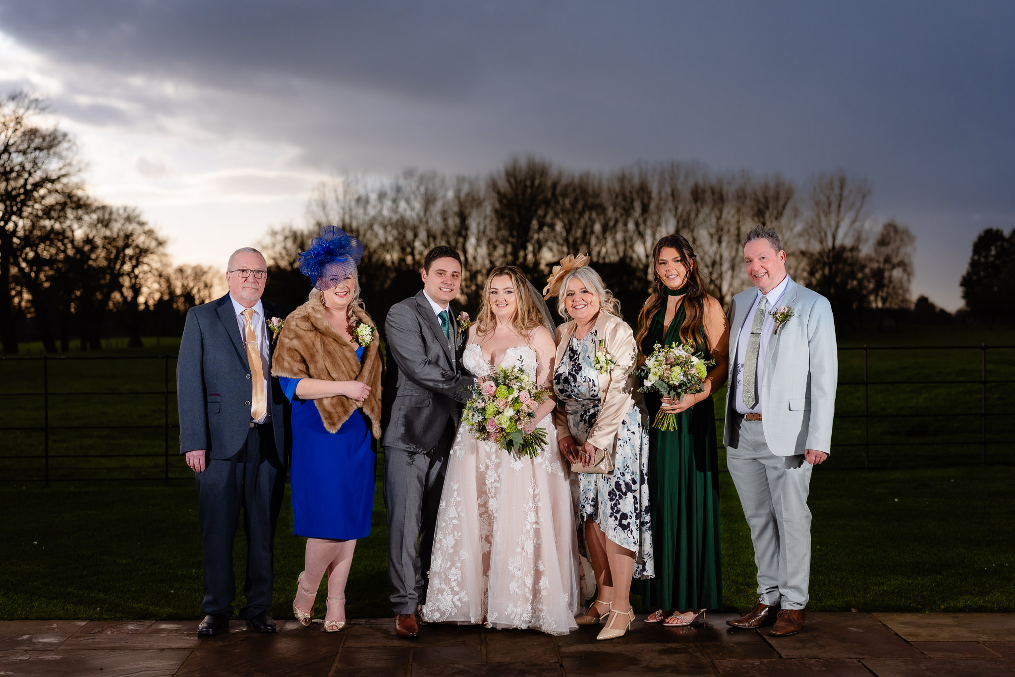Bride with her parents and family in a formal portrait at Merrydale Manor, Cheshire wedding photographer