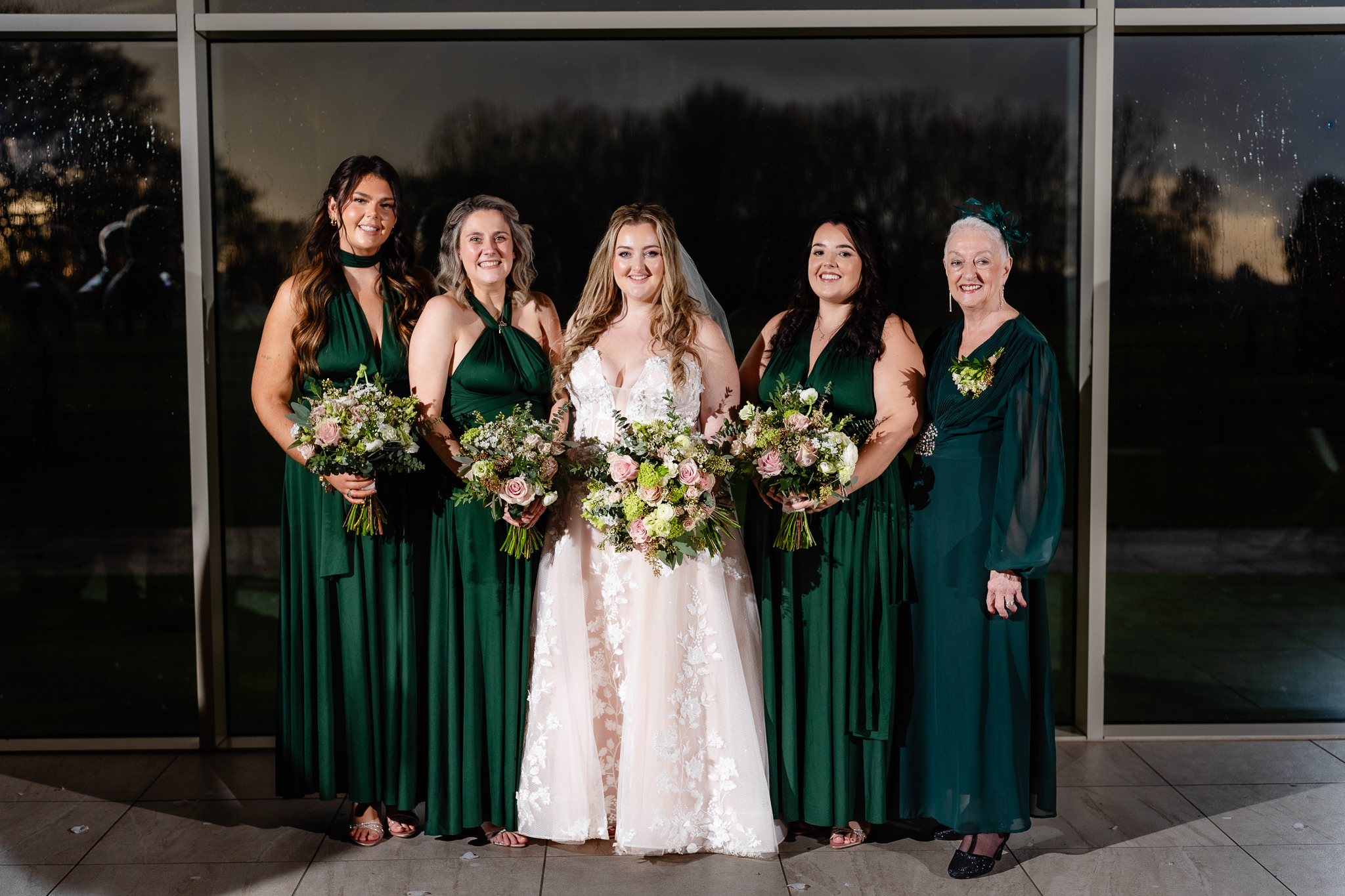 Bride with her bridesmaids in dark green dresses at Merrydale Manor, Cheshire wedding photographer
