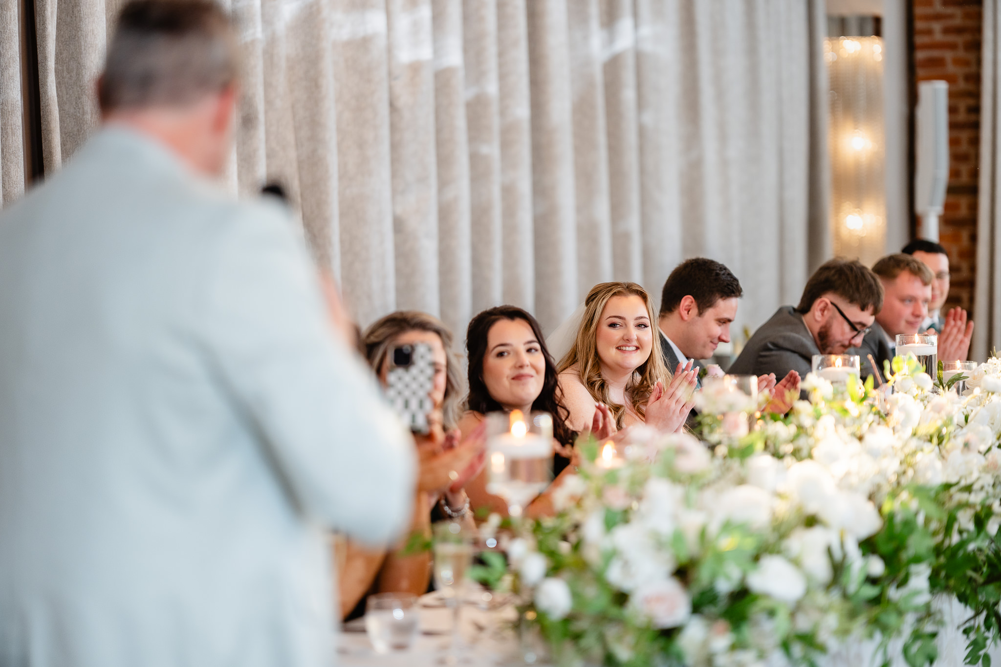 Wedding guests applauding during speeches at Merrydale Manor, Cheshire wedding photographer