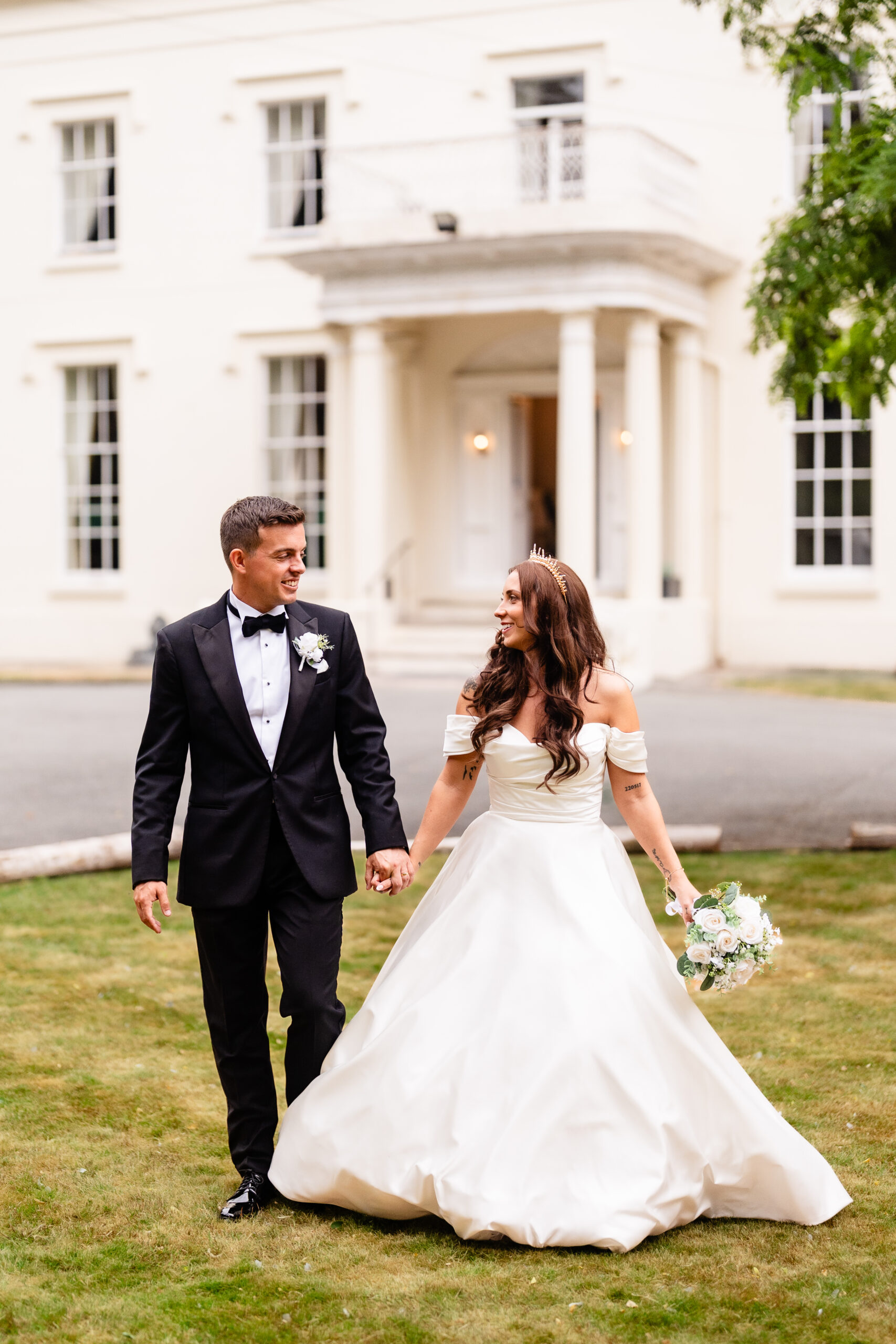 Bride and groom portrait in front of Rainhill Hall, Liverpool wedding venue