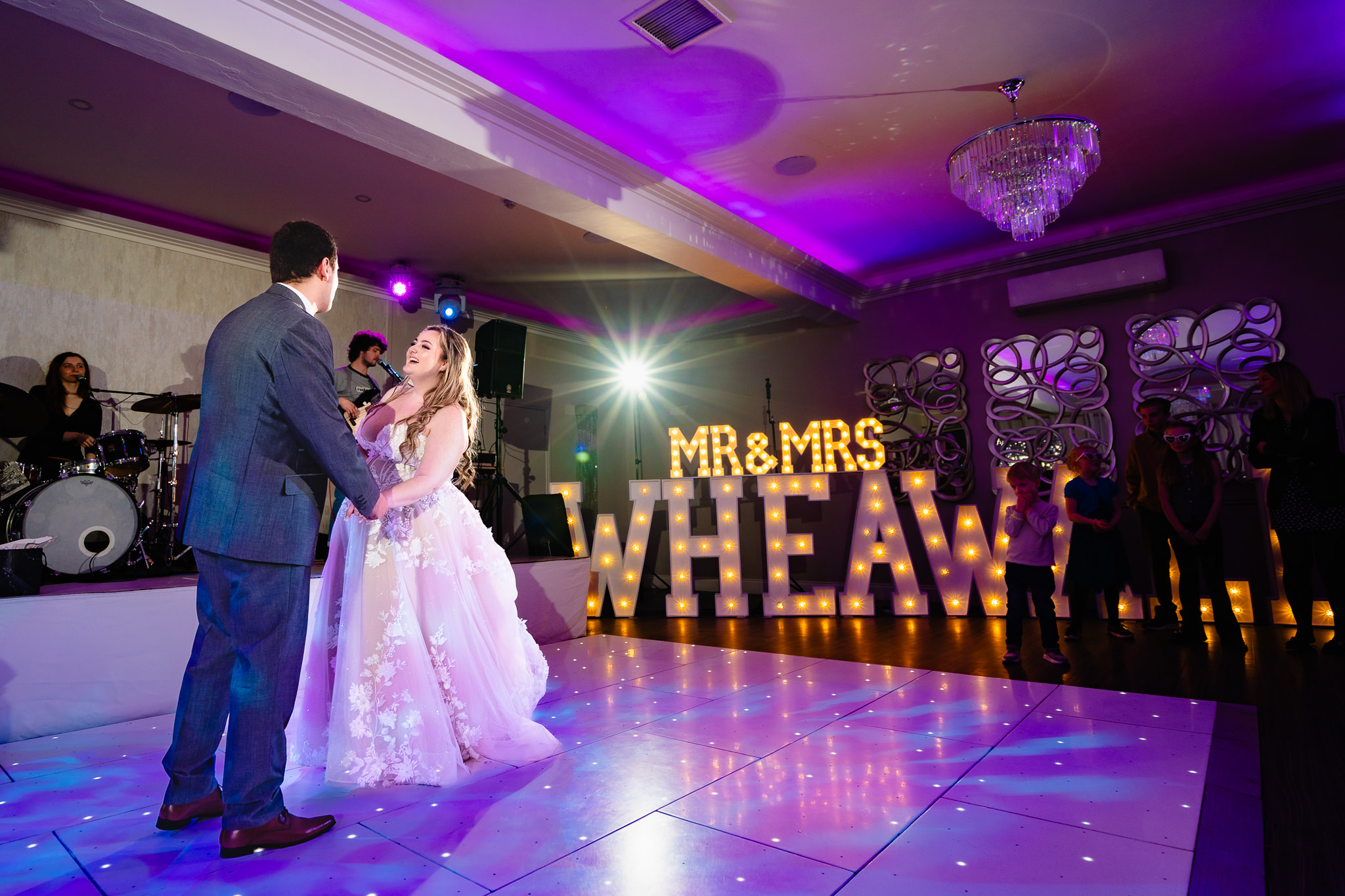 Bride and groom’s first dance with live band and light up letters at Merrydale Manor wedding reception