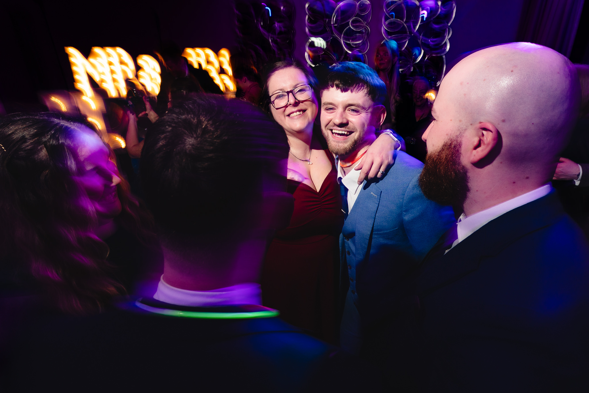 Group of friends celebrating on the dance floor at Merrydale Manor wedding, Cheshire wedding photographer