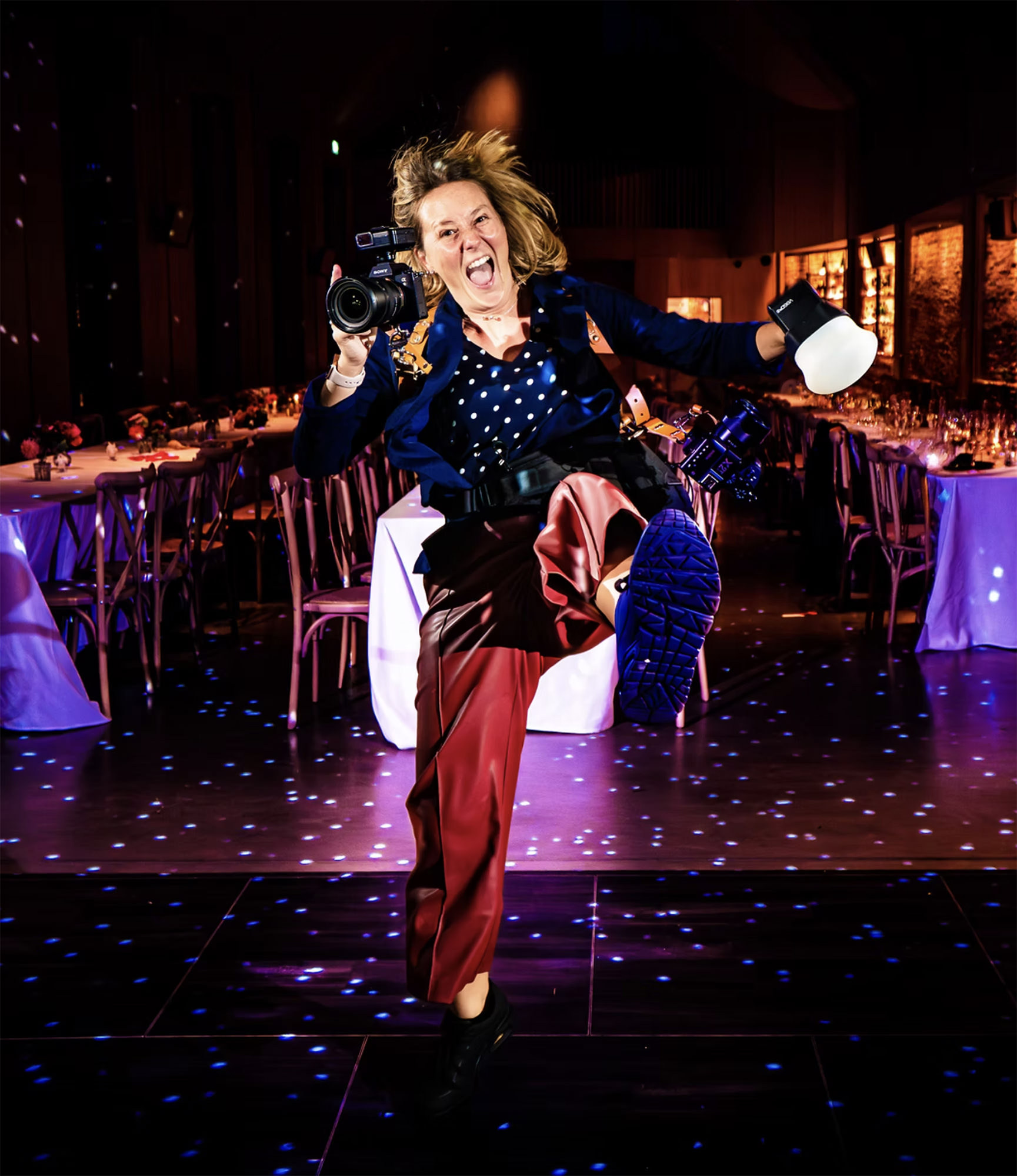 Emma Staley, wedding photographer, working on the dance floor at a wedding reception