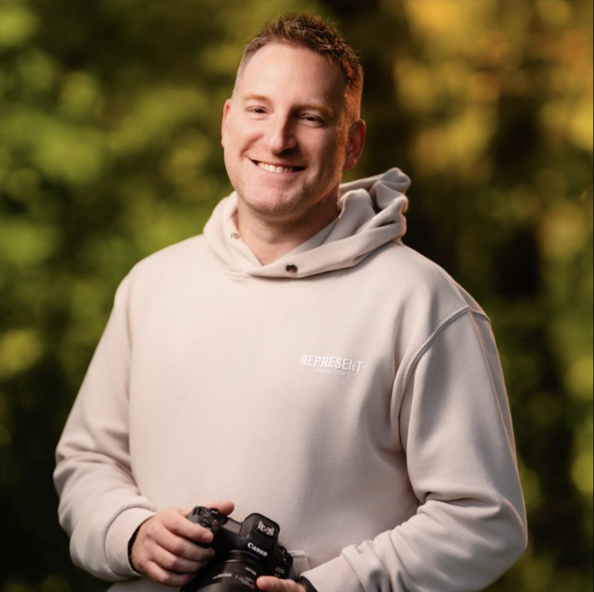 Andy Wilkinson, wedding photographer and mentoring client, holding his camera