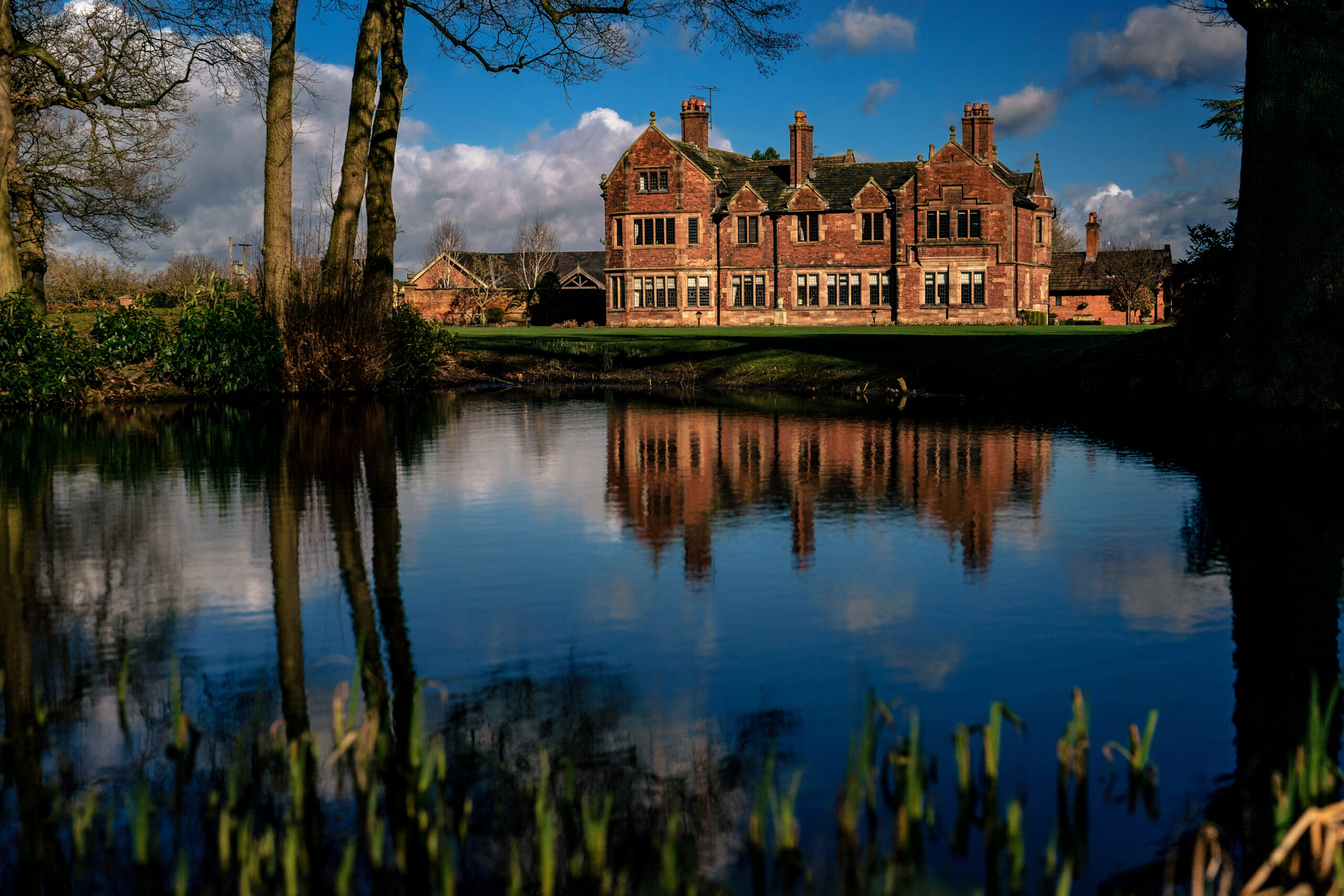 Colshaw Hall reflected in the lake on a bright winter morning, Cheshire wedding photographer capturing the venue before the day began