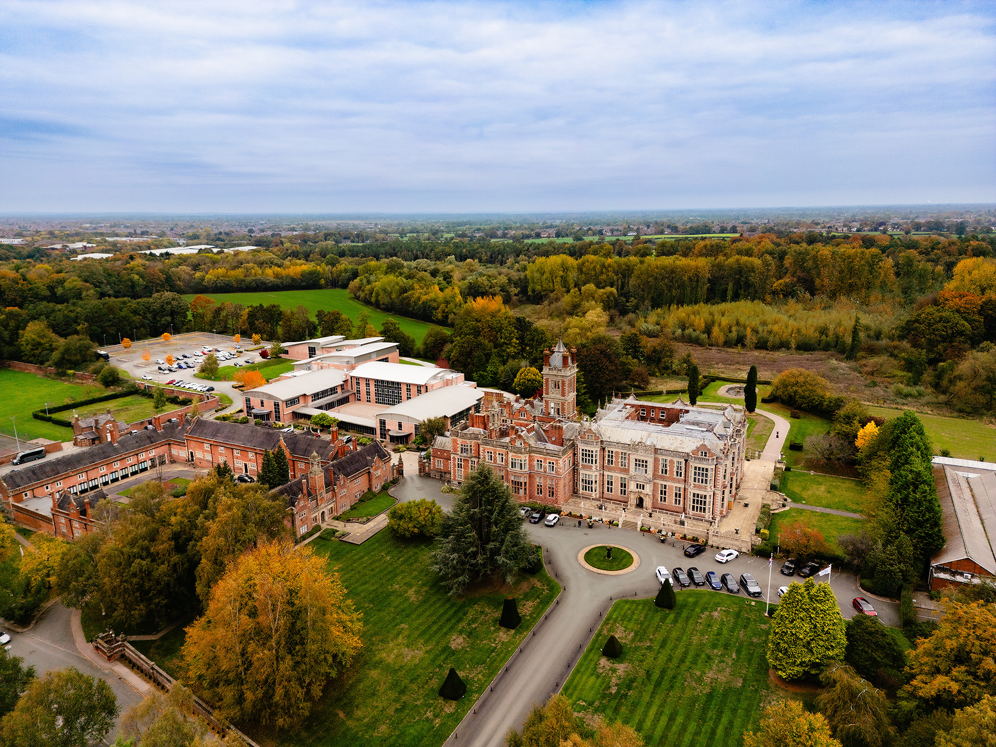 Aerial view of Crewe Hall’s red brick facade and grounds ahead of Annie and Tom’s wedding day, Crewe Hall wedding photographer