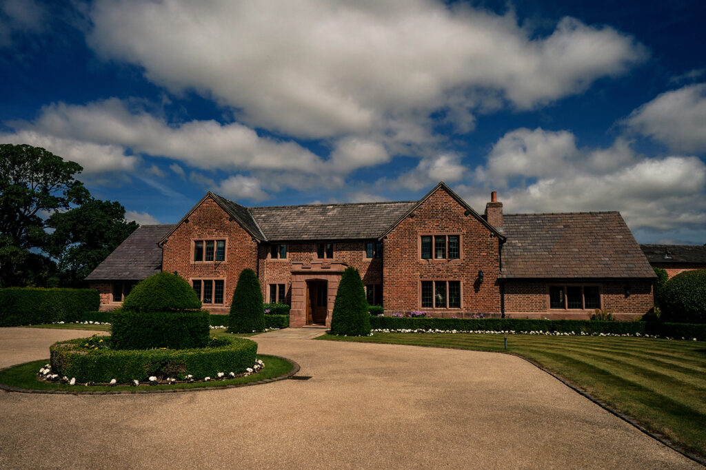 The red brick manor house and front lawns at Merrydale Manor near Knutsford on a sunny wedding morning, Cheshire wedding photographer
