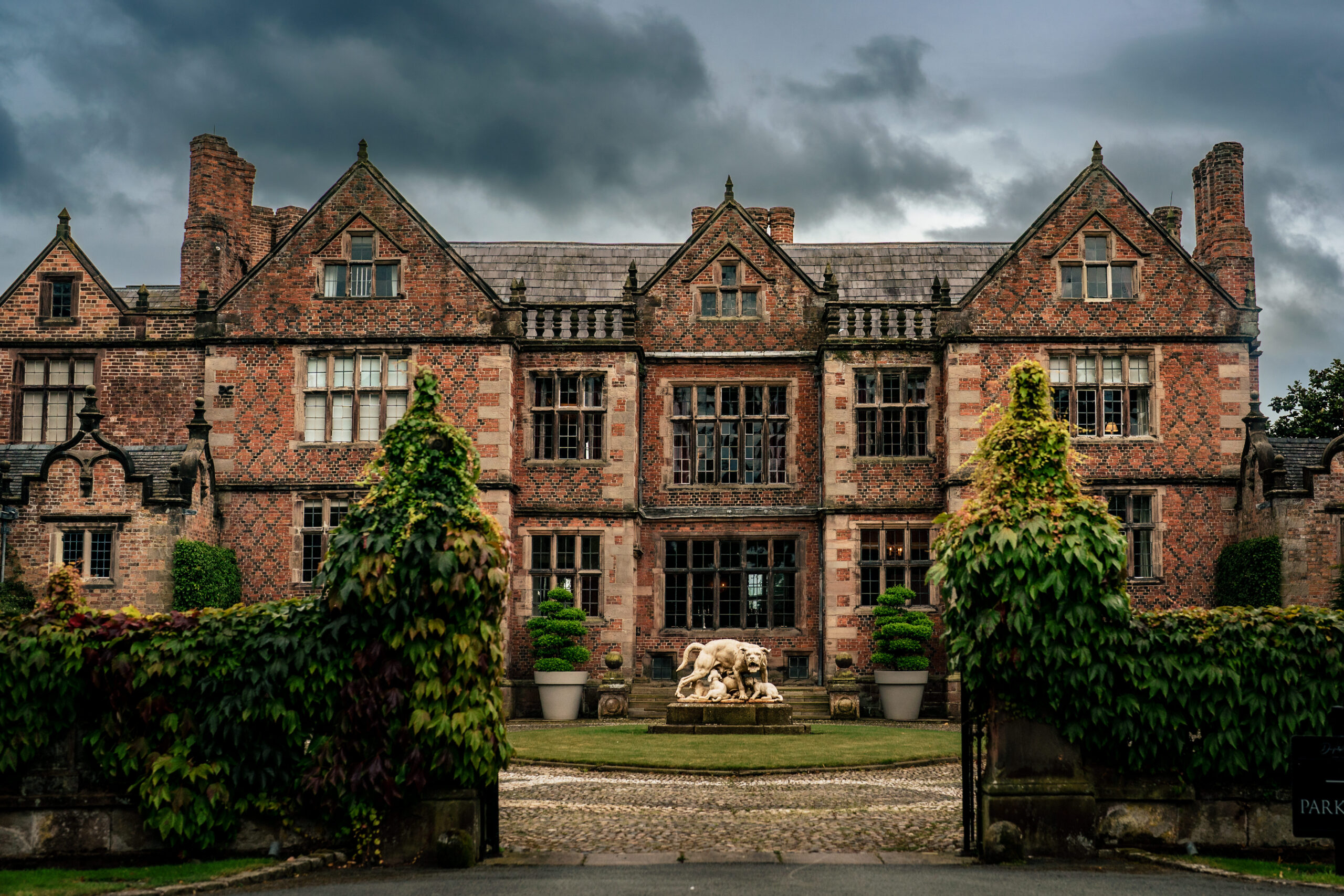 The Jacobean front of Dorfold Hall in Nantwich under heavy summer cloud, Dorfold Hall wedding photographer