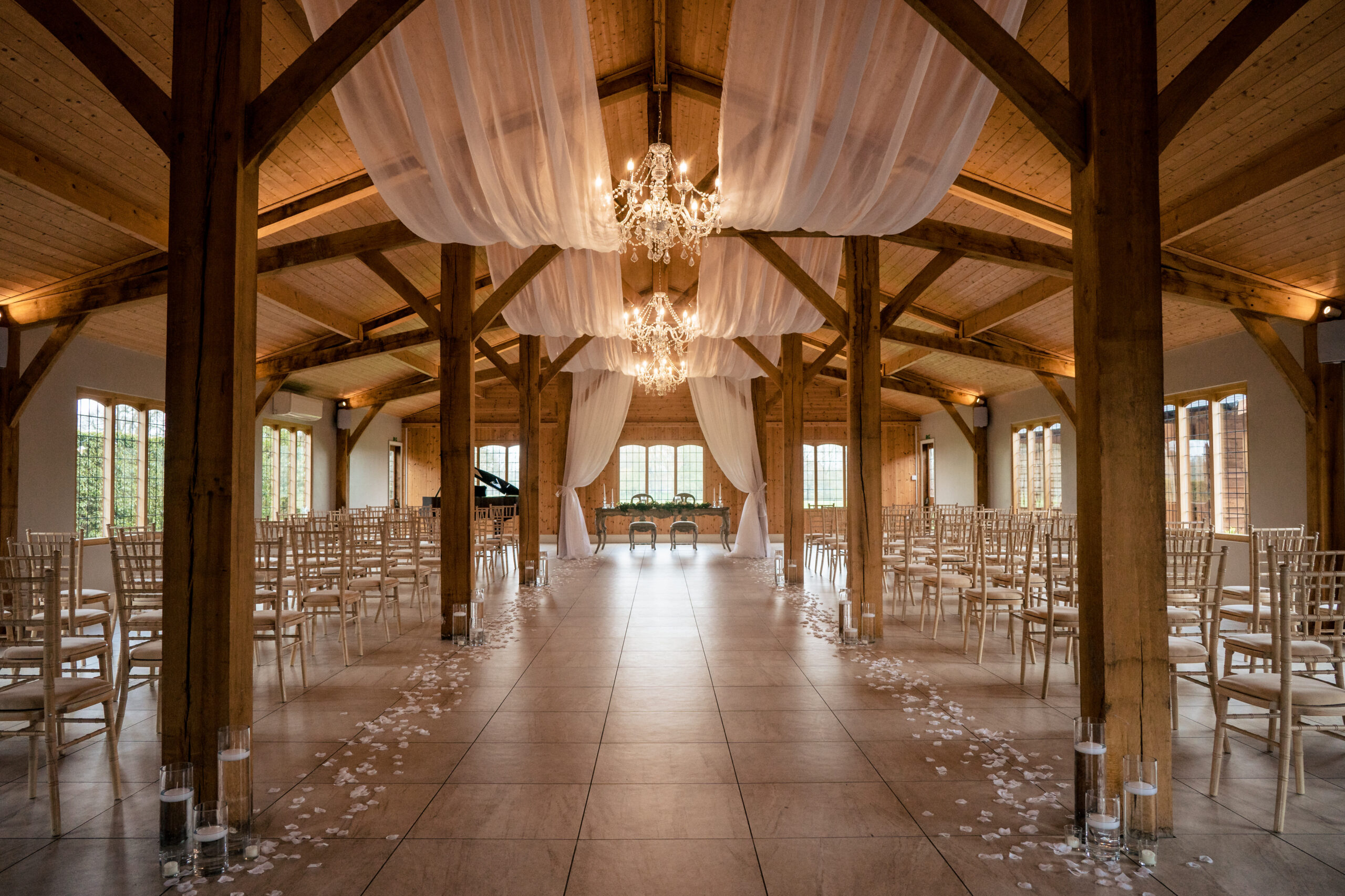 The Ceremony Room at Merrydale Manor dressed with white drapes, chandeliers and candles before guests arrive