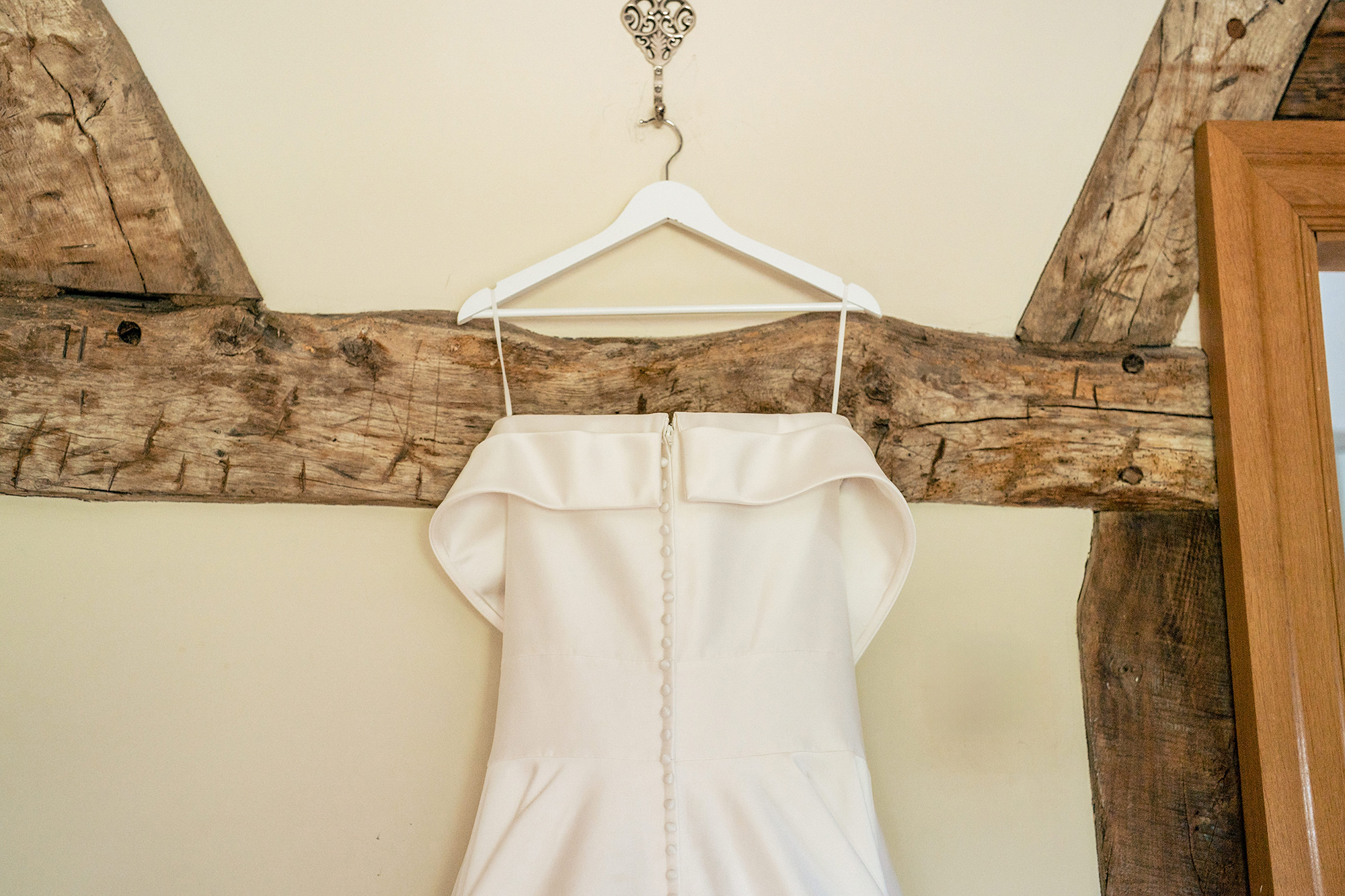 Laura's wedding dress hanging in the barn before getting ready, Merrydale Manor wedding photographer