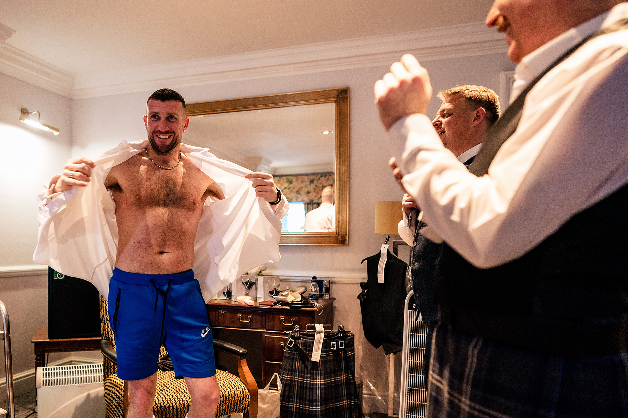 A quiet moment getting dressed together on the morning of the wedding, Crewe Hall wedding photographer