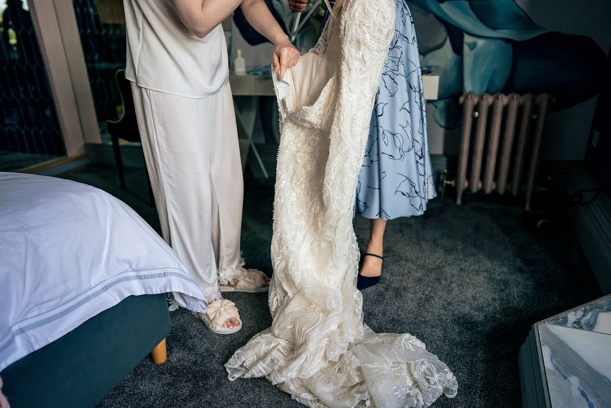 Bride being helped into her wedding dress by her mum on the morning of her Salt House wedding, Staffordshire wedding photographer