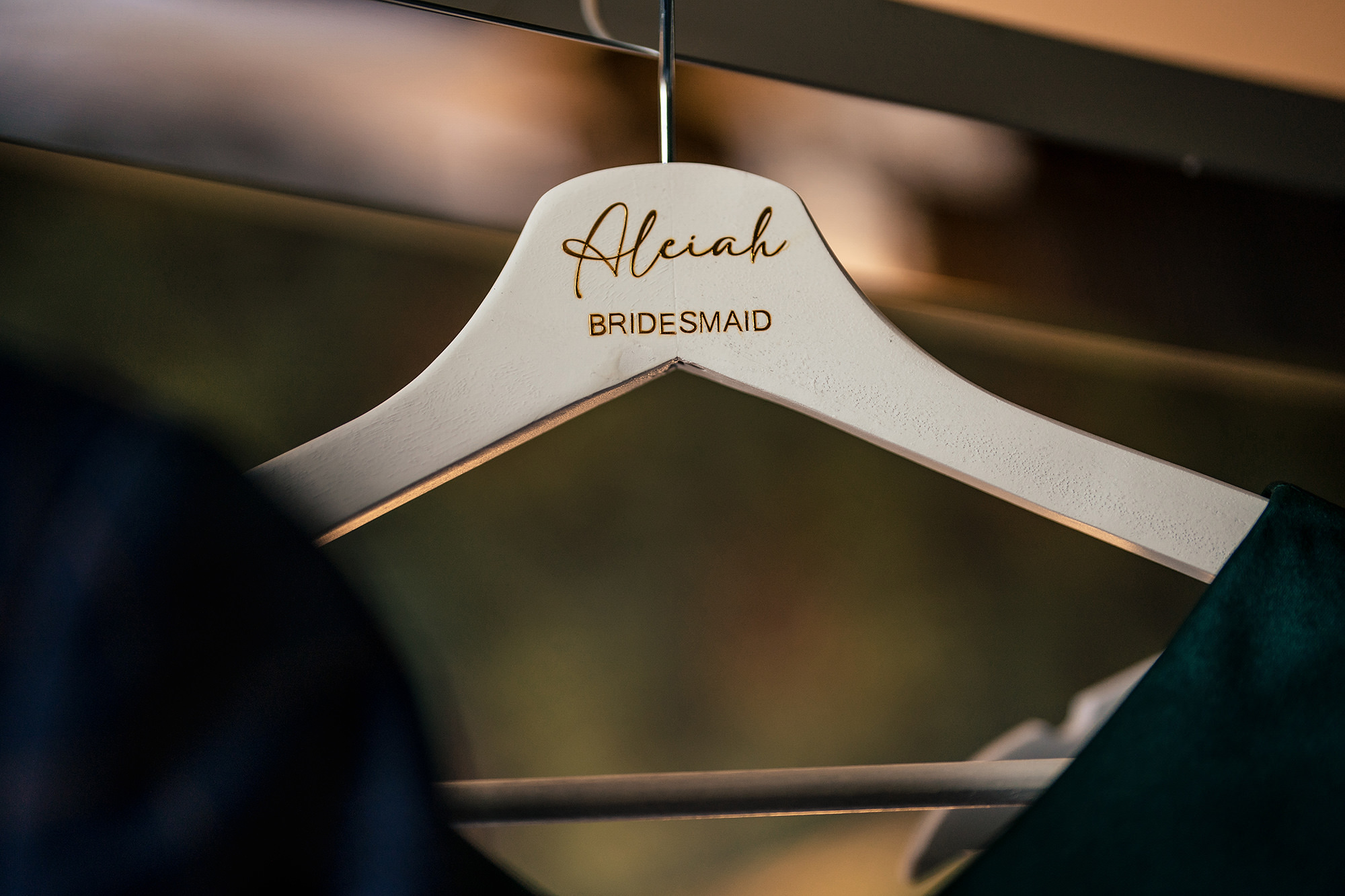 A bridesmaid’s dress hanger with her name tag before Chloe’s Salt House wedding