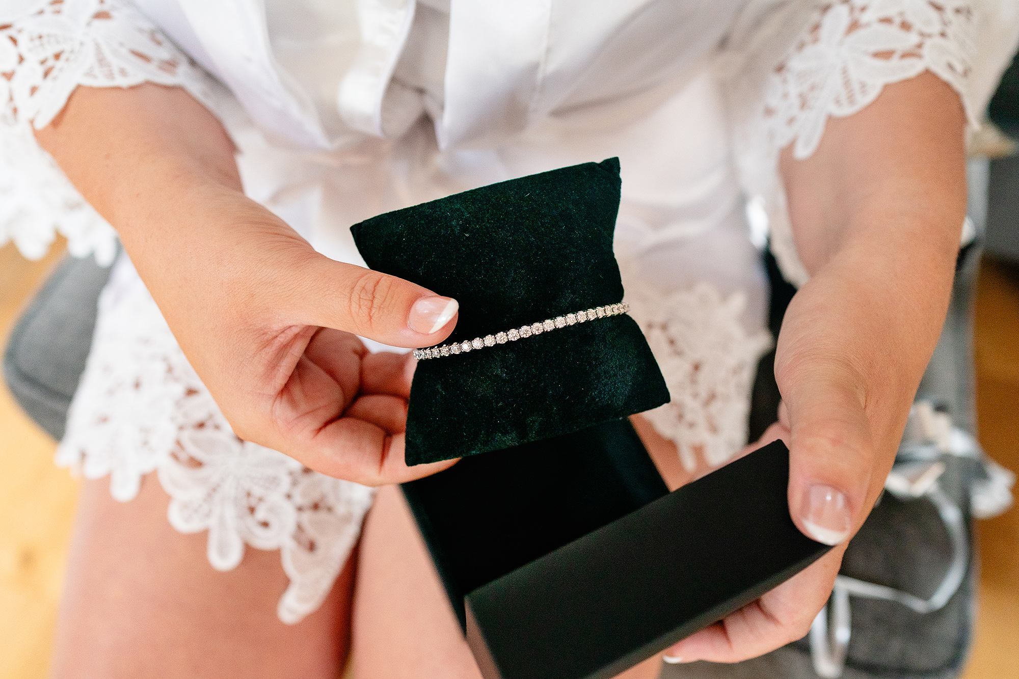 Hands opening a velvet box to reveal Chloe’s wedding day jewellery