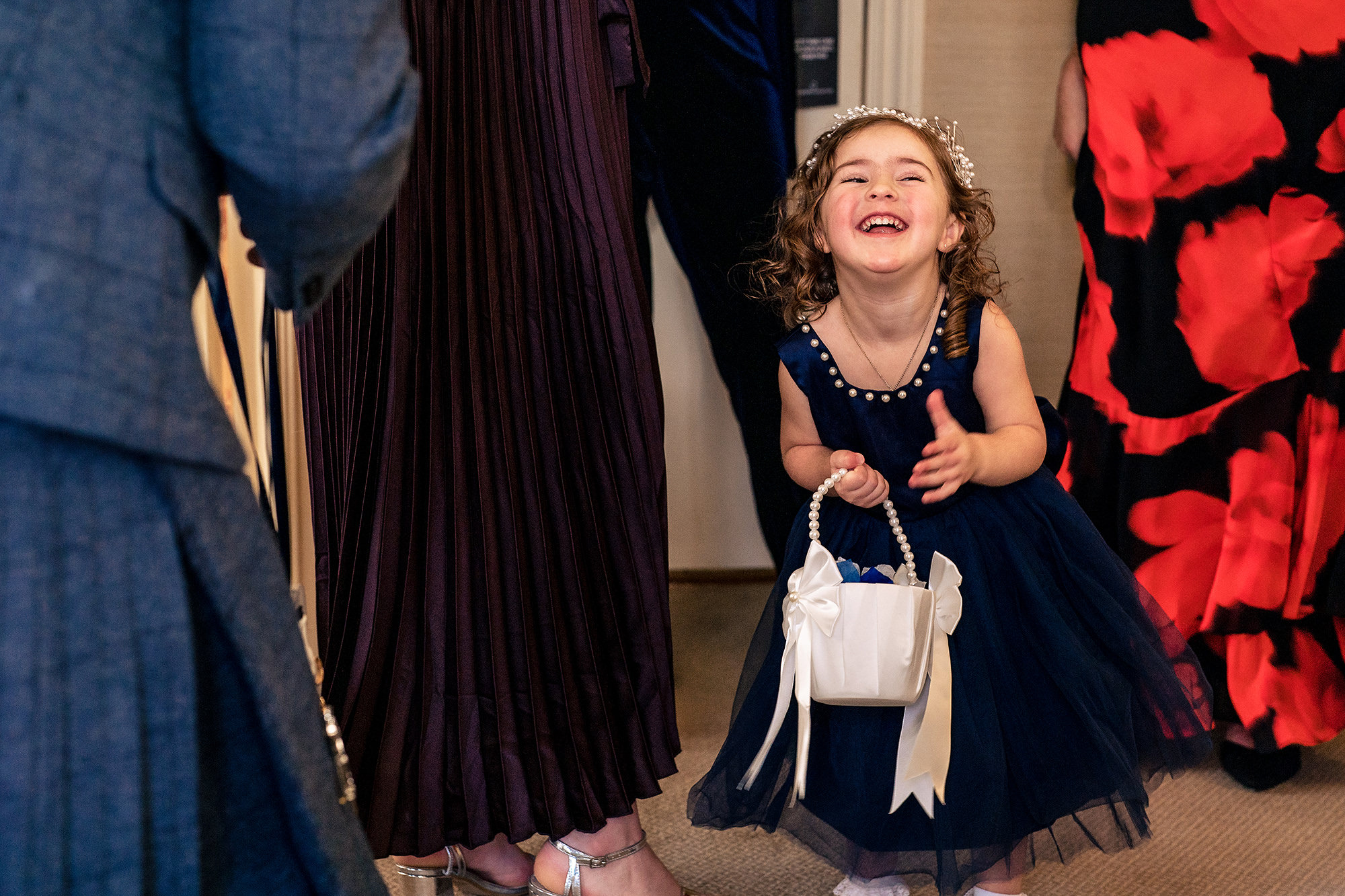 The flower girl laughing in her navy dress as the morning got underway