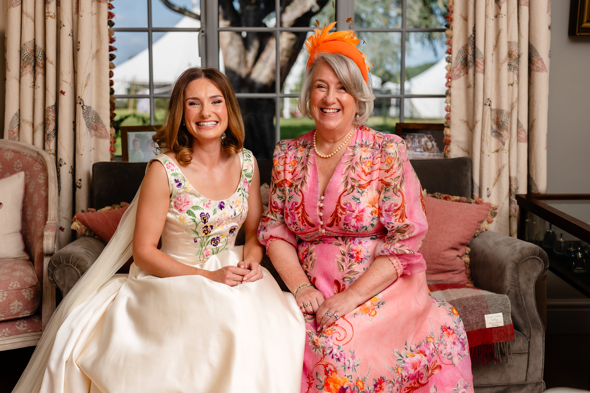 Bride sitting with her mum in the sitting room before leaving for the church
