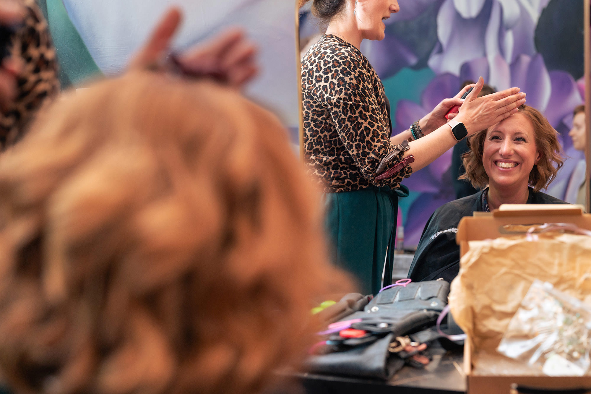 Close up of a bride’s finished hairstyle with a glass of champagne in shot during wedding morning prep