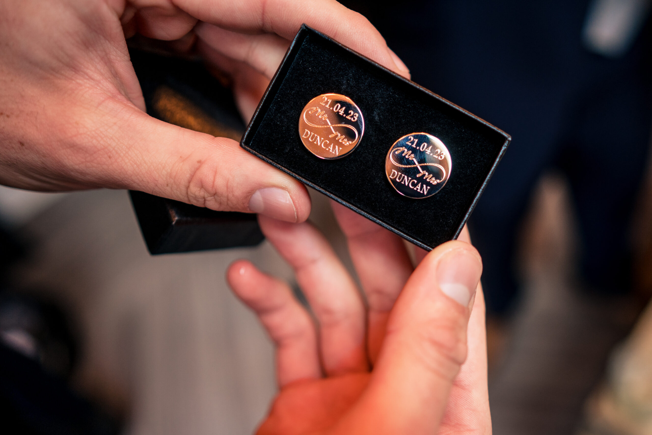 Rose gold cufflinks engraved Mr and Mrs Duncan 21.04.23 held open in their box