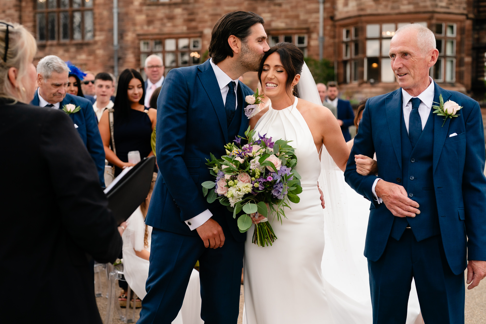 Groom kissing his new wife on the head moments after being pronounced married, Salt House wedding photographer
