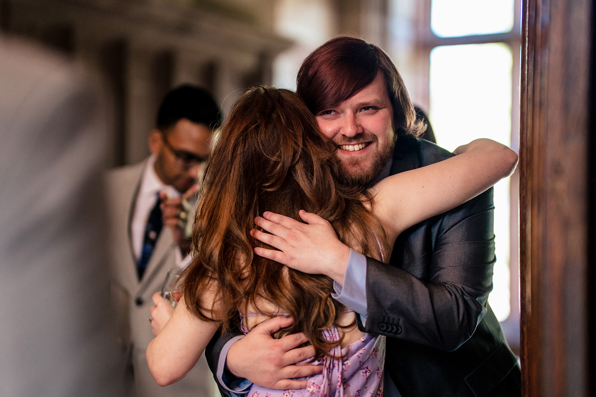 Bride laughing while wrapped in a big hug during morning prep, Salt House wedding photographer