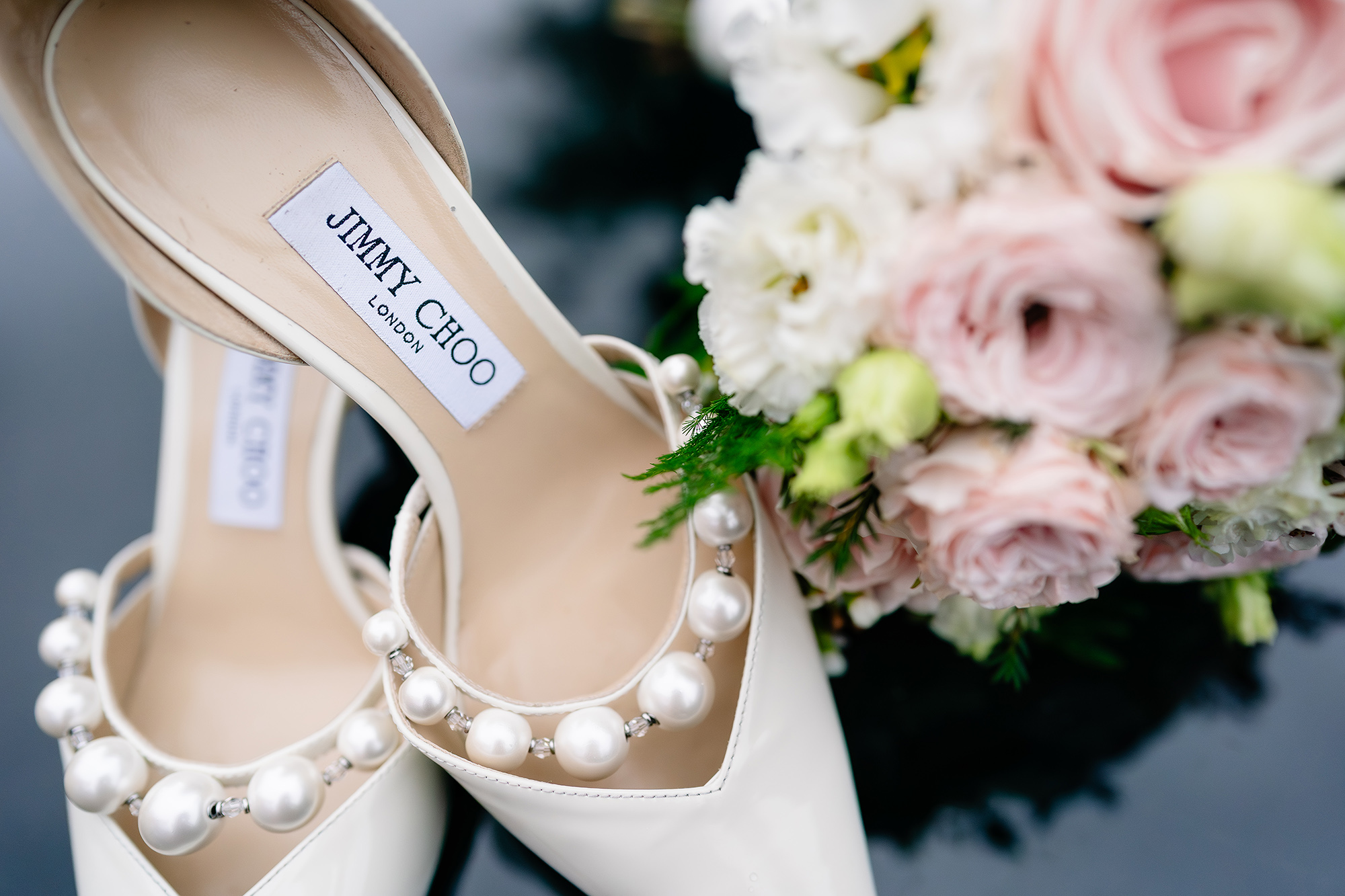 Chloe’s pearl detail wedding shoes hung up with her bouquet, Wrenbury Hall wedding photographer