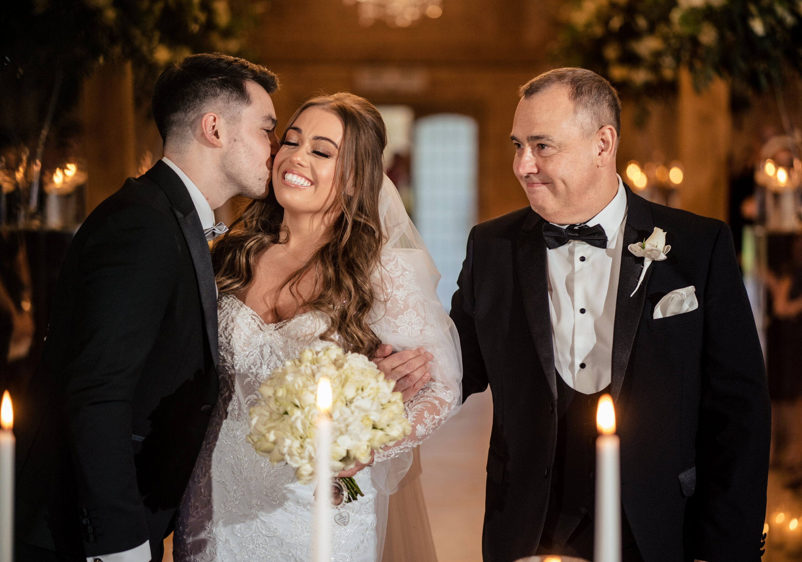 Jamie kissing Abbie on the cheek as she reaches the front of the aisle, Merrydale Manor wedding photographer