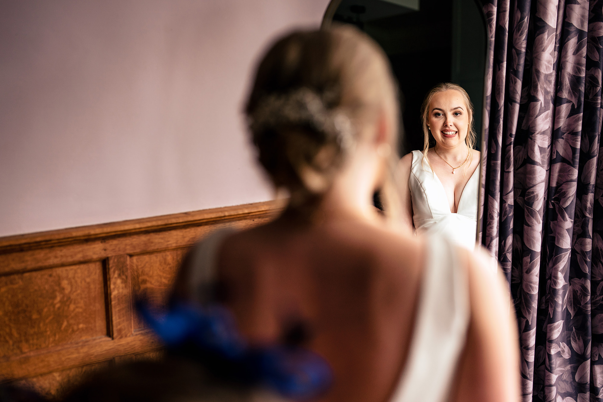 Chloe in her wedding dress reflected in the mirror at Salt House