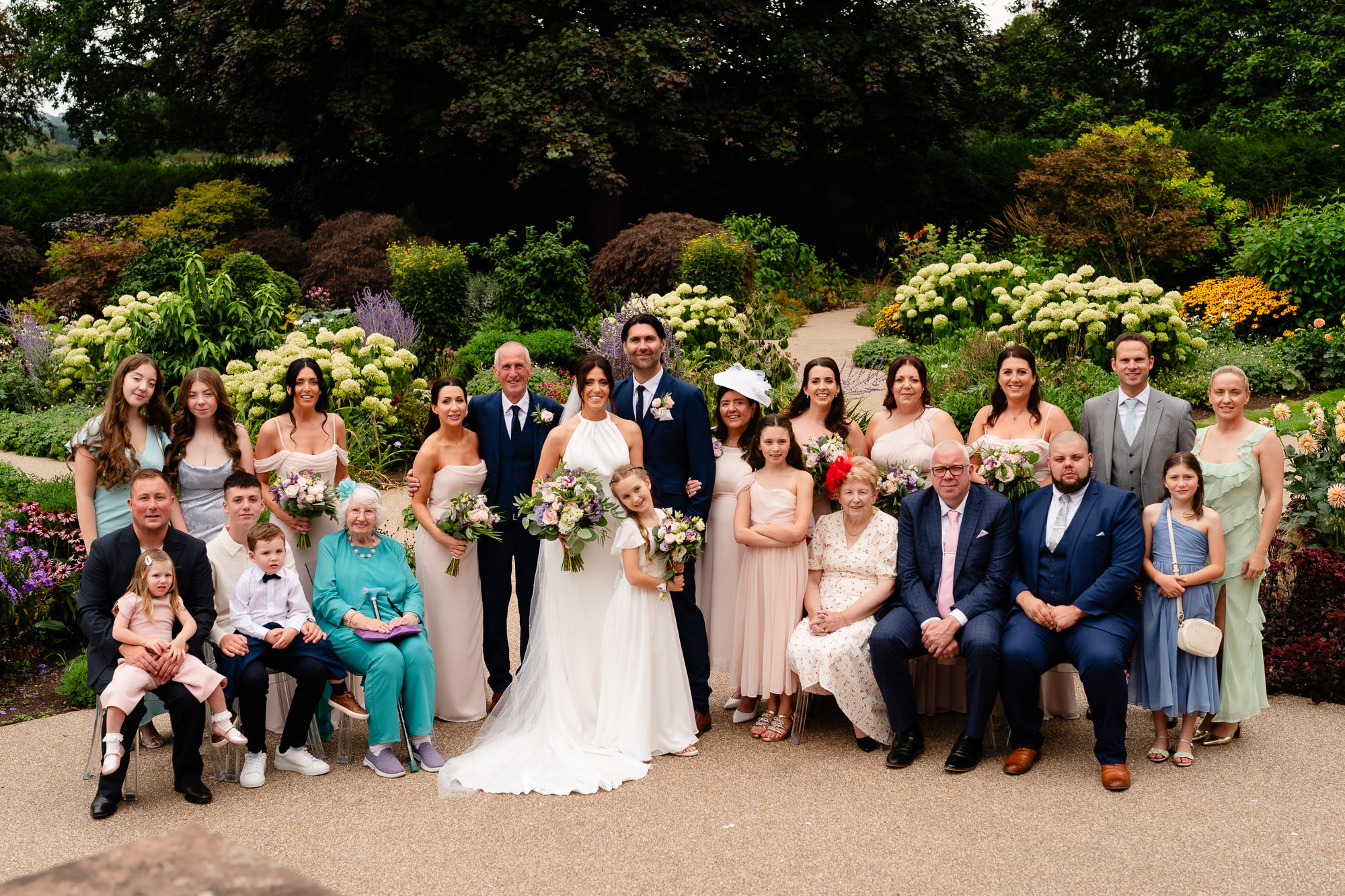 The full wedding party gathered in the gardens at Salt House, Staffordshire wedding photographer