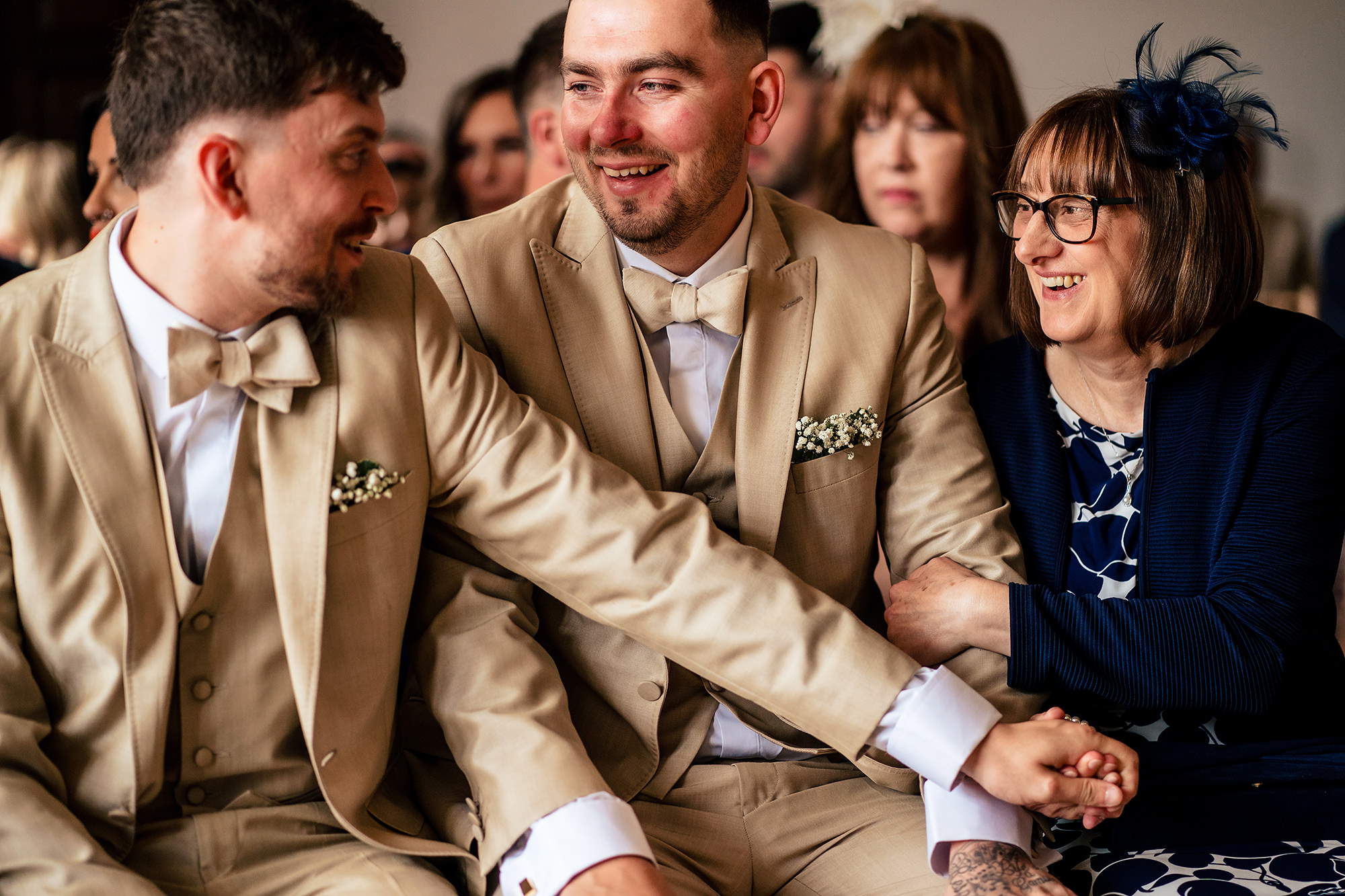 Groomsmen sharing a laugh during the ceremony at Salt House, Staffordshire