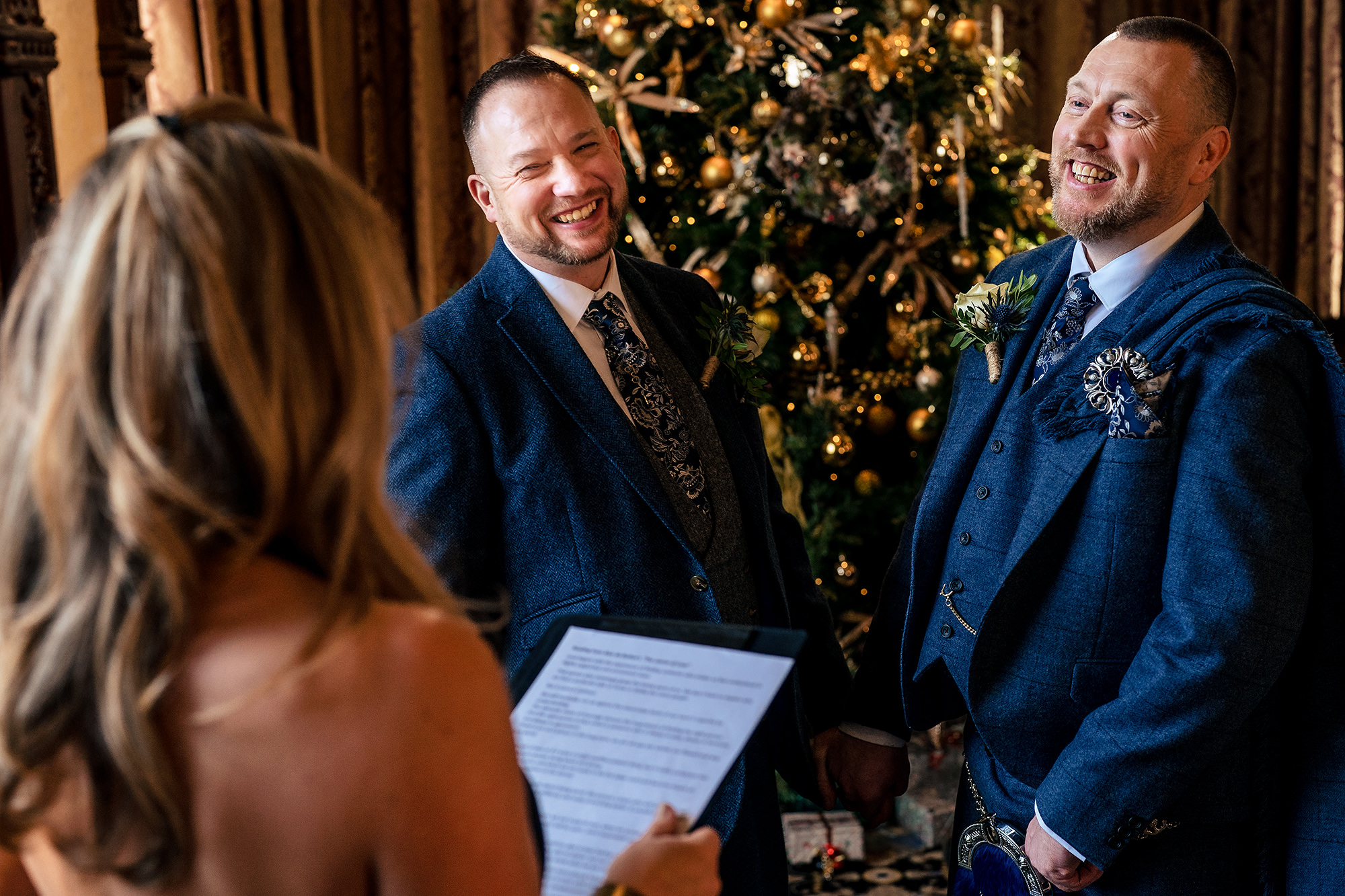 Reading vows in front of the Christmas tree during the ceremony at Crewe Hall