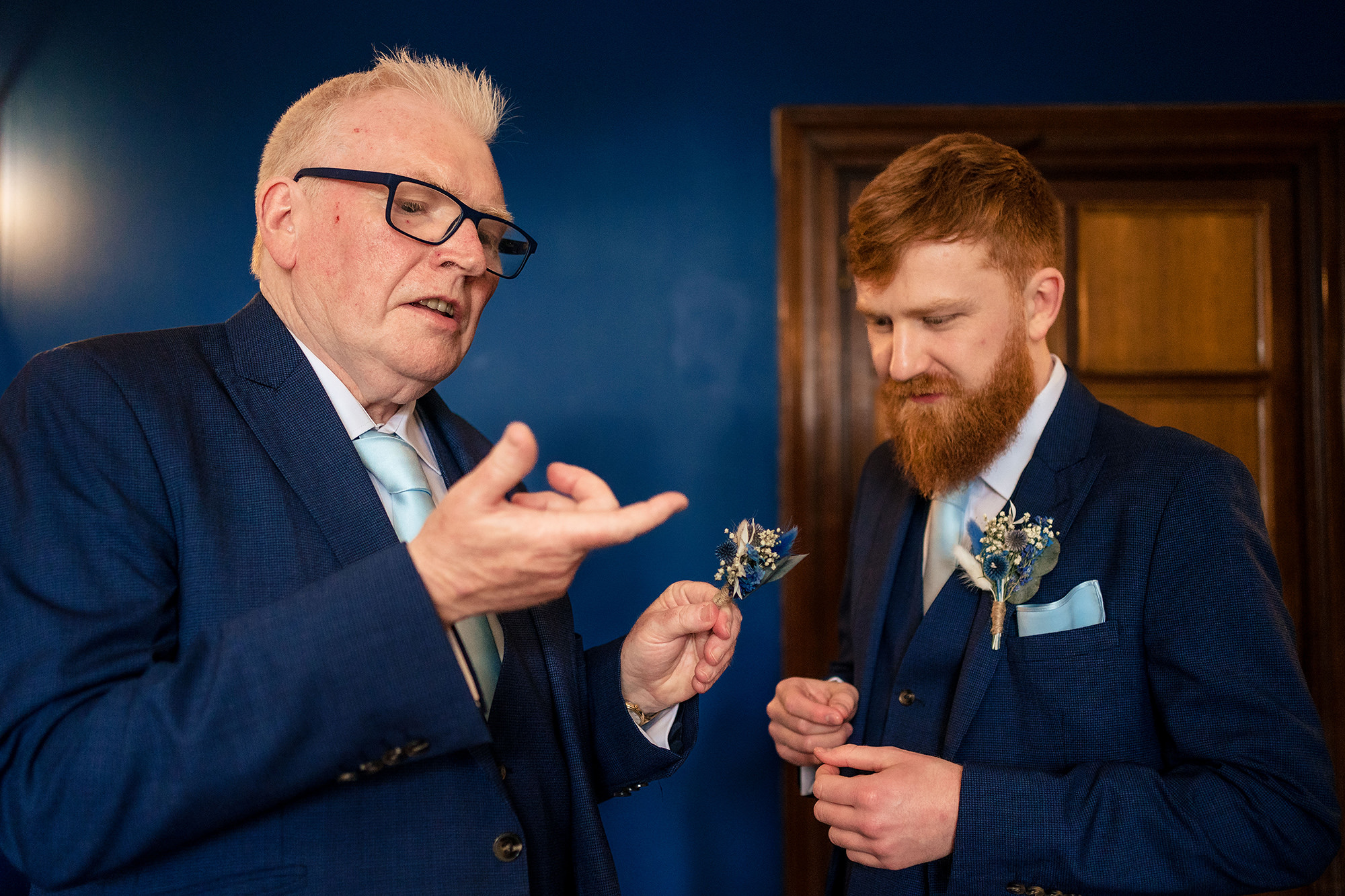 Groom’s dad fixing his buttonhole before the ceremony at Salt House, Staffordshire wedding photographer
