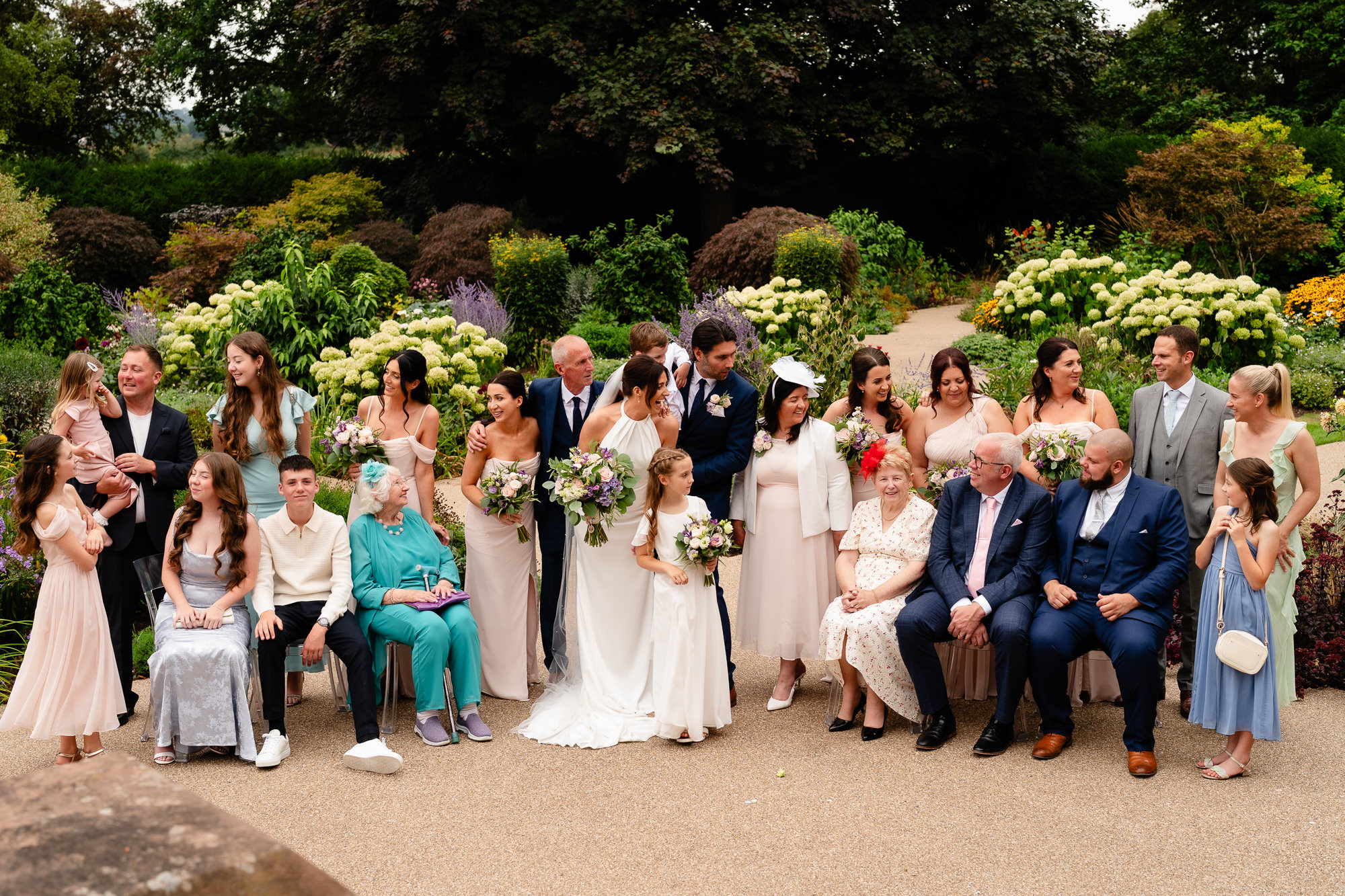 The wedding party laughing together in the gardens at Salt House, Staffordshire wedding photographer