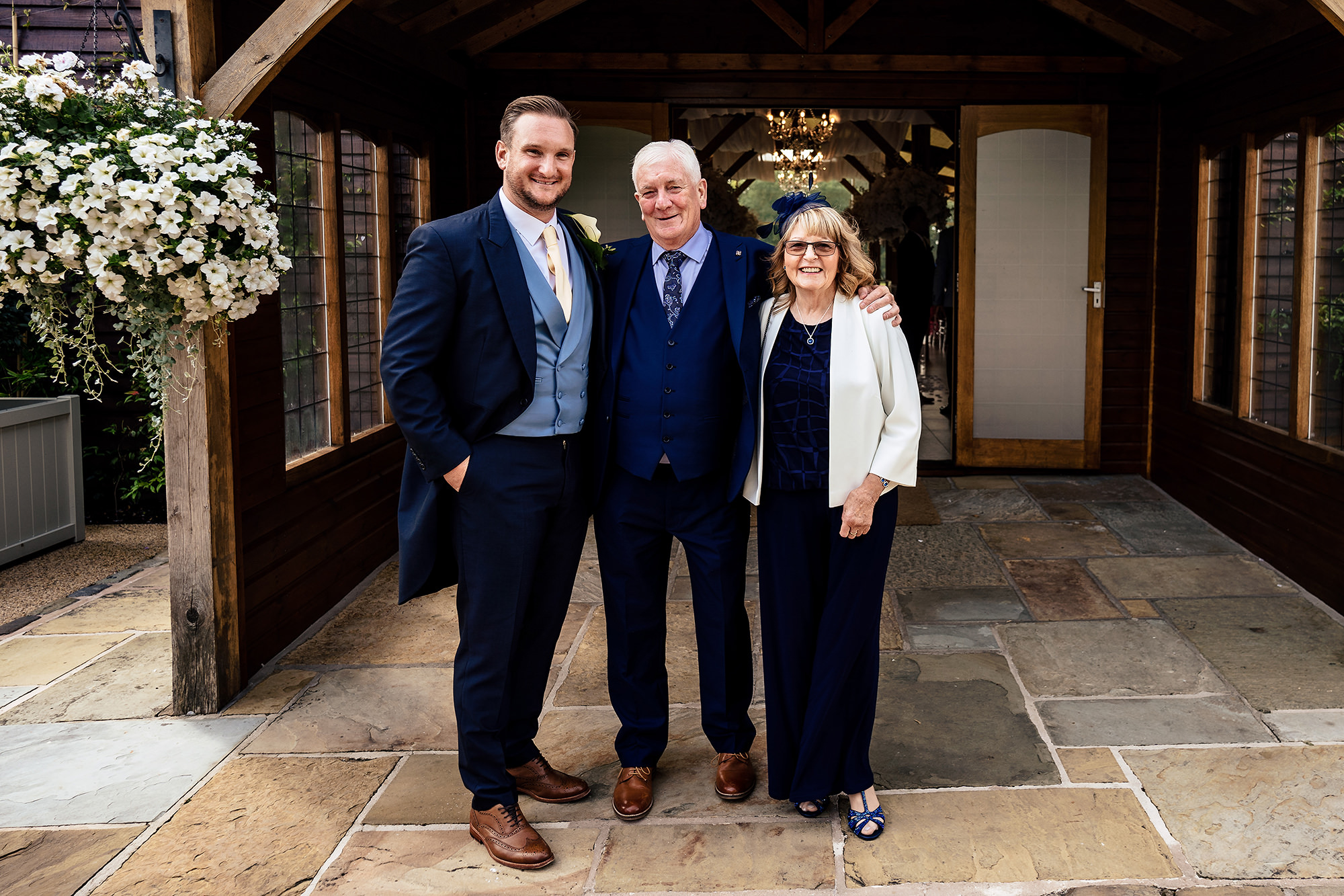 Ryan with his parents outside the manor before the ceremony, Merrydale Manor wedding photographer