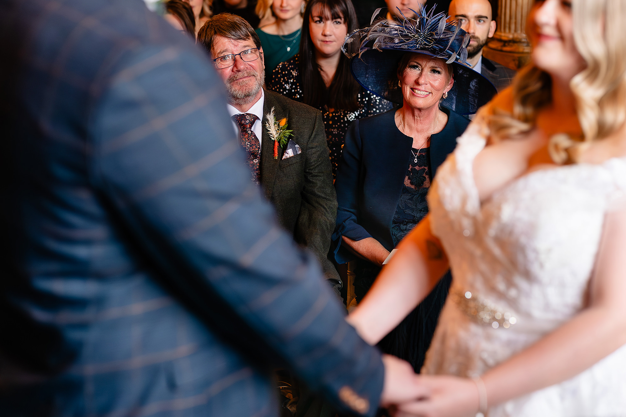 Annie and Tom holding hands during their vows at Crewe Hall, Cheshire wedding photographer