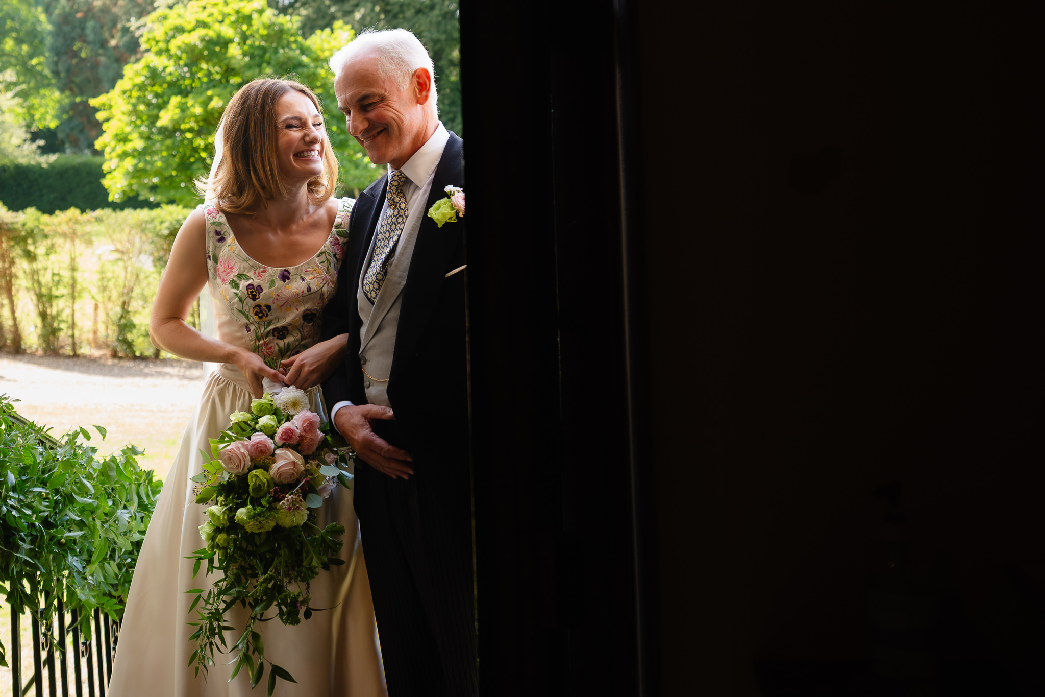 Bride and her father sharing a quiet moment in the church porch before walking in