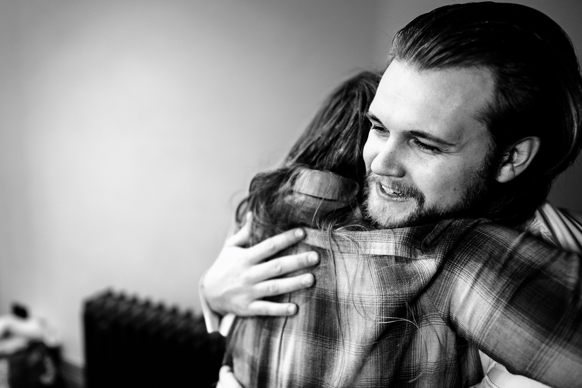 A hug among the groomsmen during getting ready at Salt House