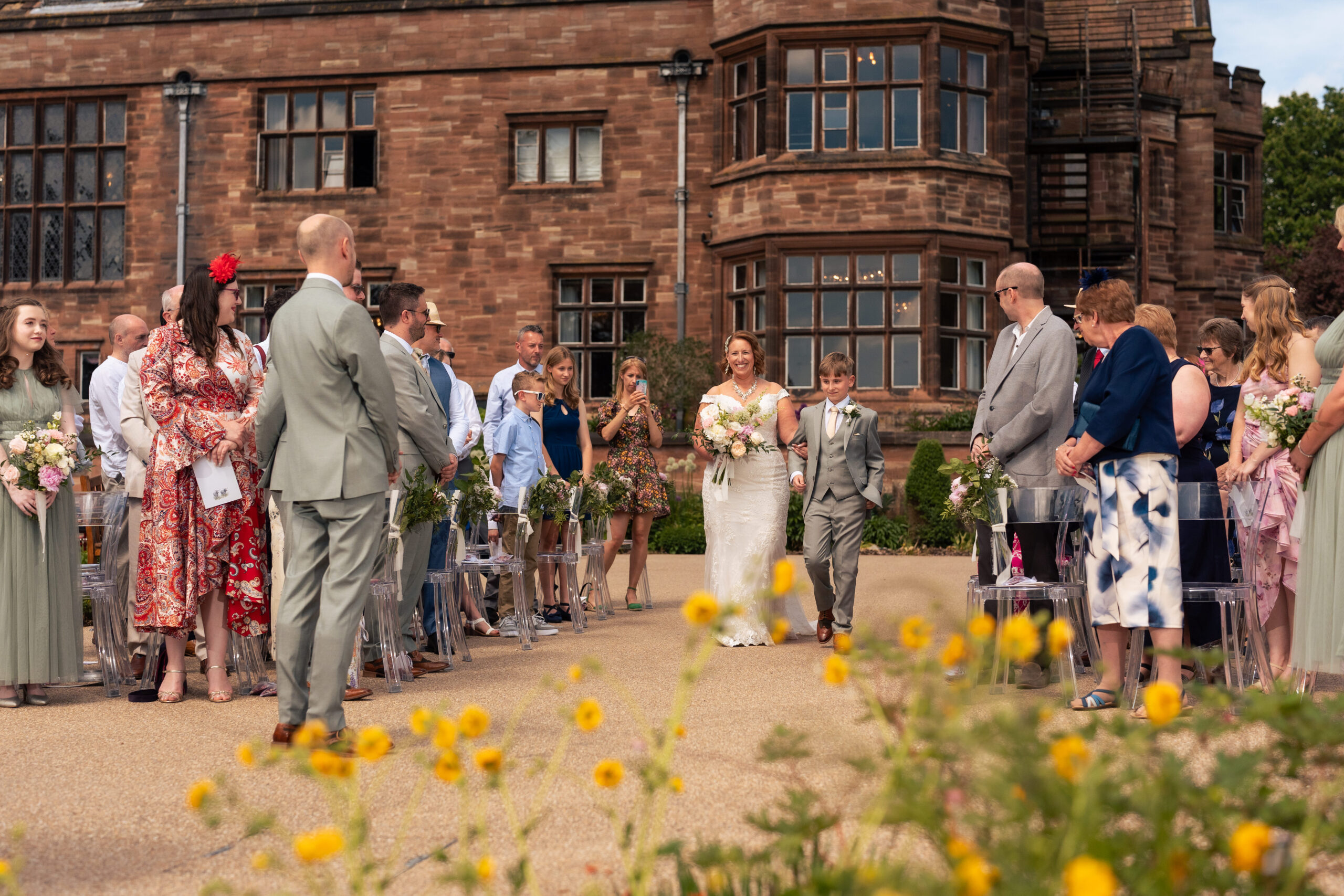 Wedding guests seated in the gardens at Salt House waiting for the ceremony to begin