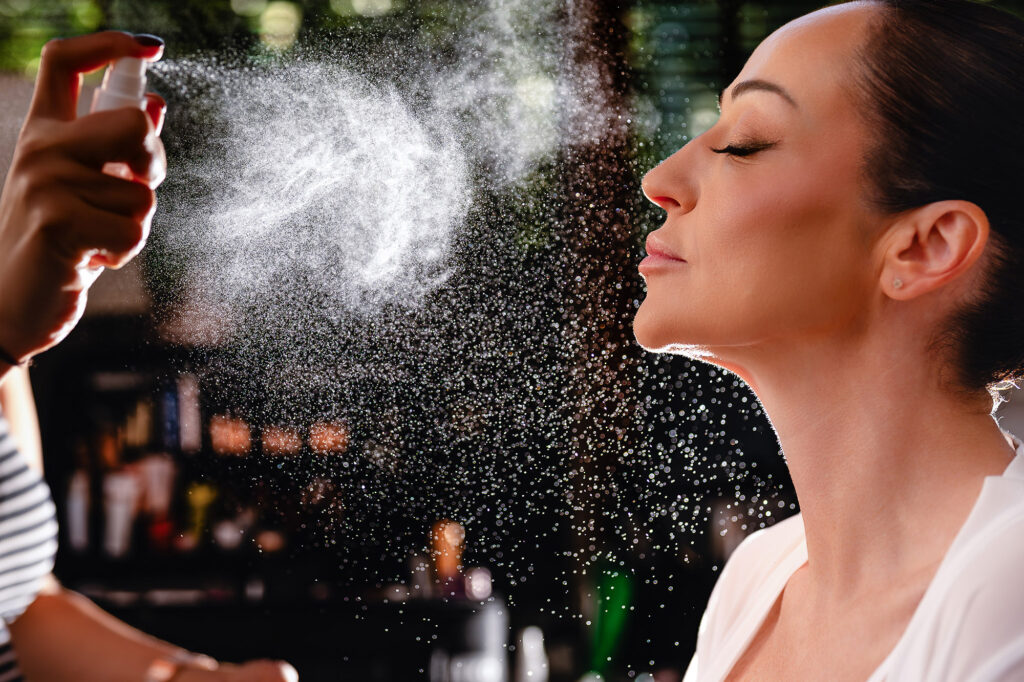 Setting spray misting over Kim's face as her makeup is finished, Swancar Farm Country House, Nottingham wedding photographer