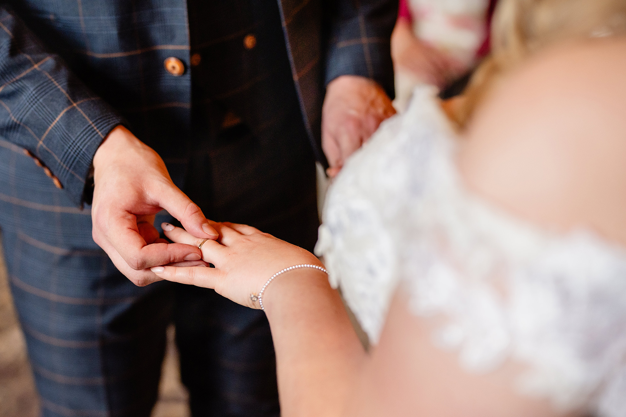 Close up of the wedding ring being placed during the ceremony at Crewe Hall, Cheshire wedding photographer
