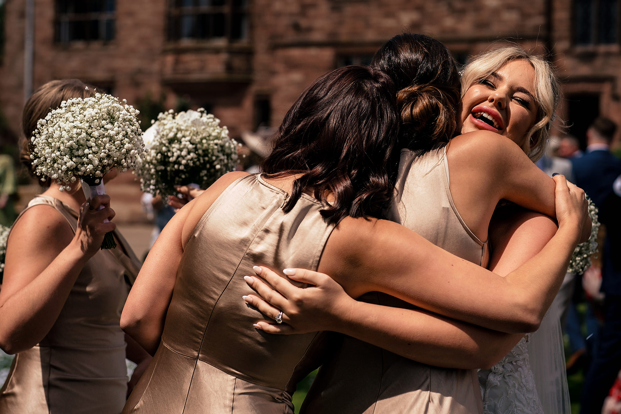 Bridesmaids hugging Jess after the confetti at her Salt House wedding
