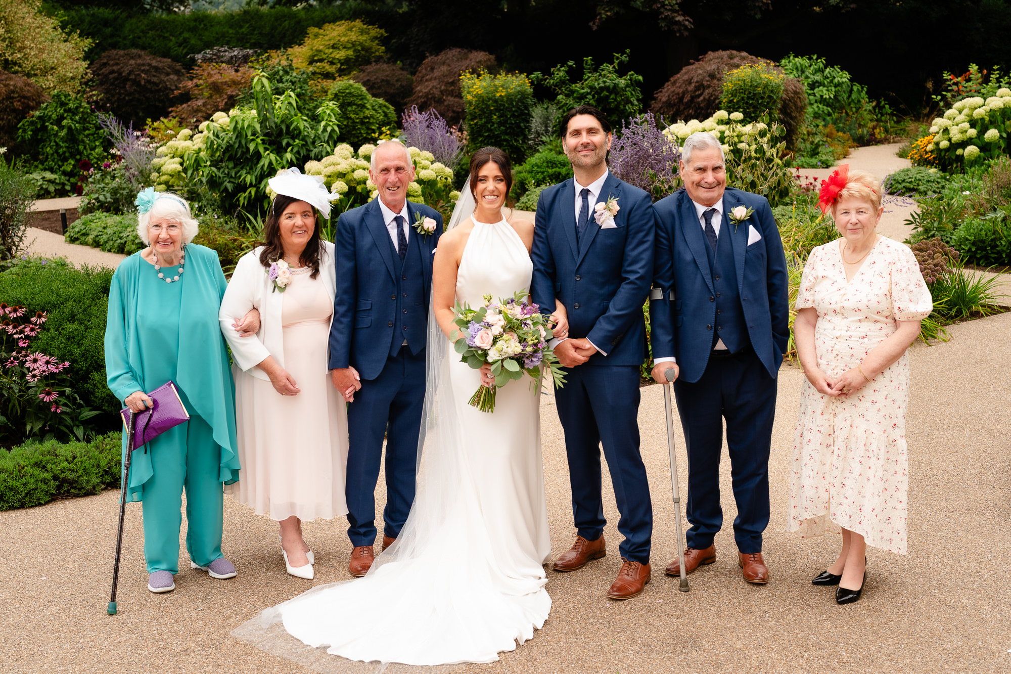 Bride and groom with extended family in the gardens at Salt House, Staffordshire wedding photographer